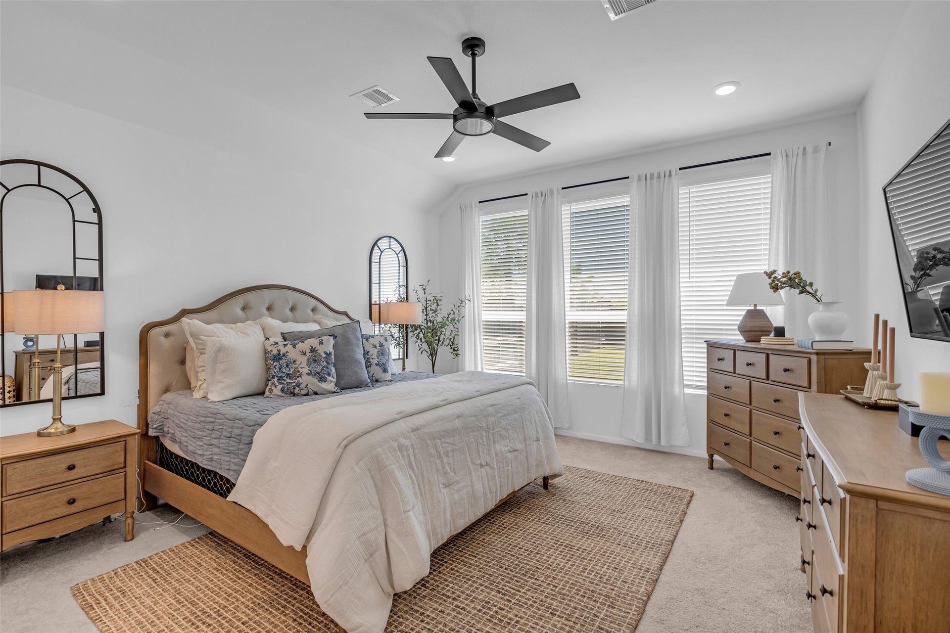 13213 Harbor Point Drive, Texas City, TX 77539 Bright and inviting bedroom featuring a cozy upholstered bed, stylish wooden furniture, and large windows that fill the space with natural light.