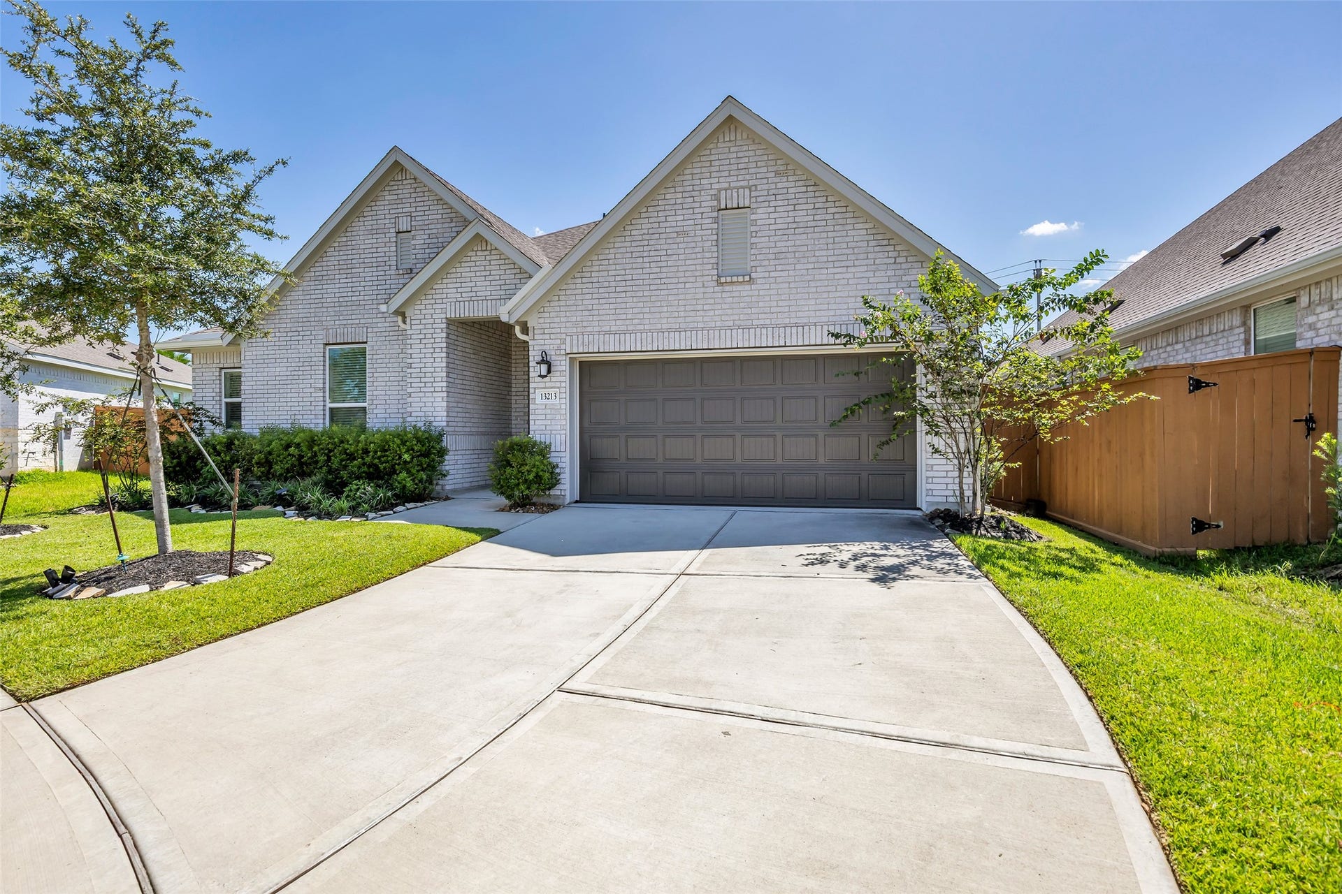 13213 Harbor Point Drive, Texas City, TX 77539 Lovely single-story home with a modern brick faade and manicured landscaping. Features a spacious two-car garage and a welcoming front entrance.