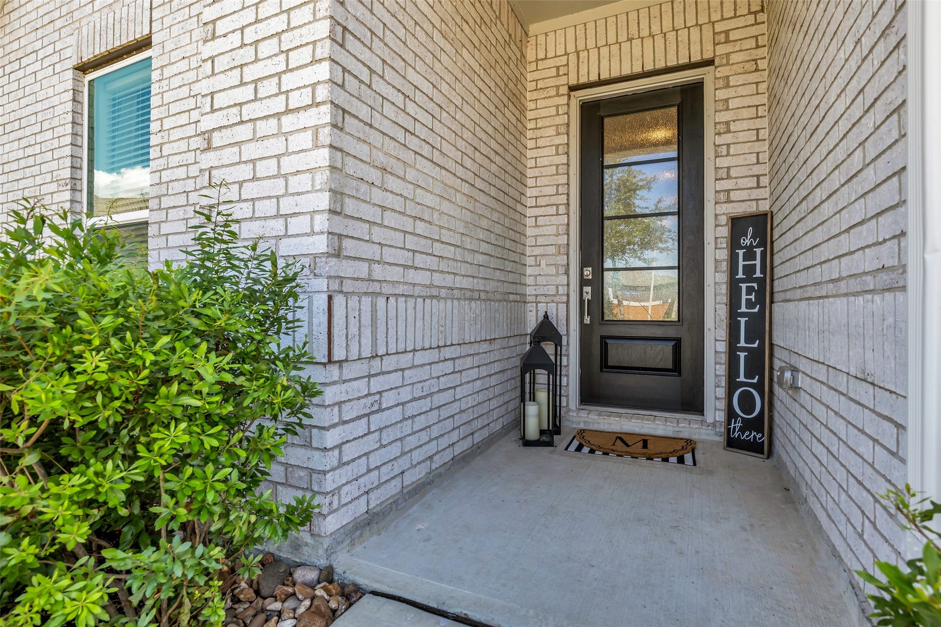 13213 Harbor Point Drive, Texas City, TX 77539 This entryway with a welcoming front door, stylish brickwork, and inviting decor, complemented by lush greenery.
