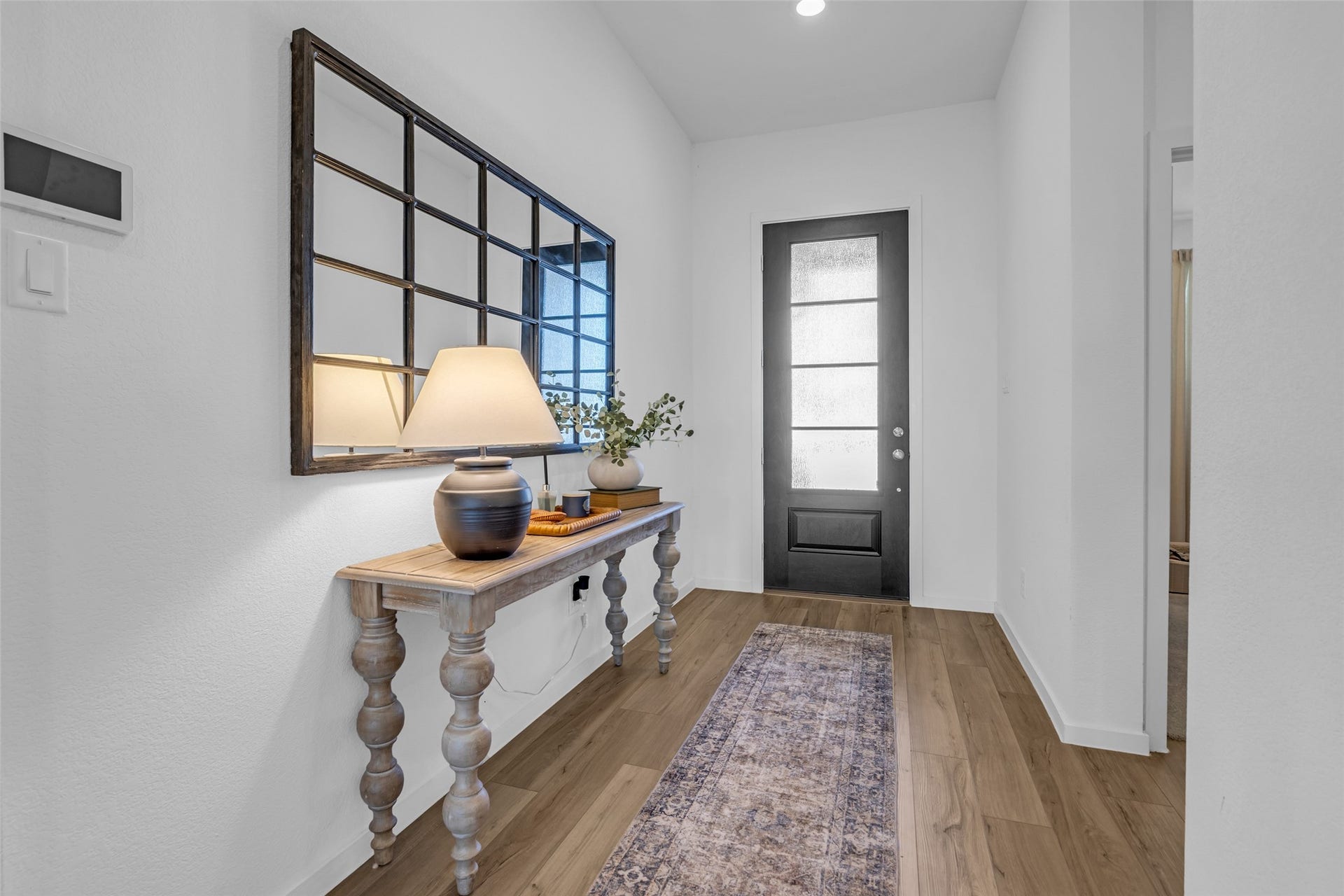 13213 Harbor Point Drive, Texas City, TX 77539 True entryway with elegant wood like flooring, a modern glass-paneled door.