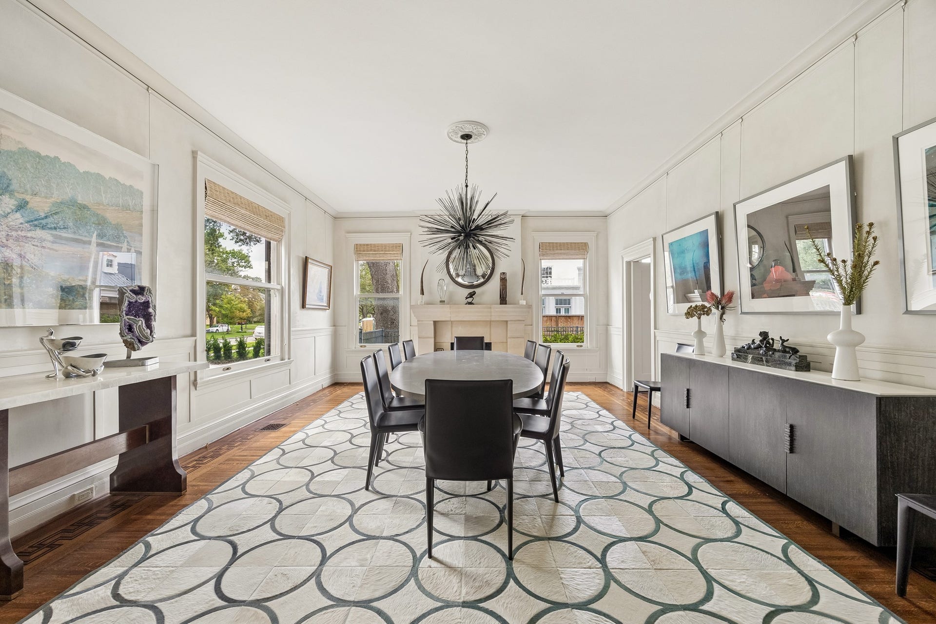 8 Courtlandt Place, Houston, TX 77006 An elegant formal dining room offers generous proportions, abundant natural light and a handsome Texas limestone fireplace surround.