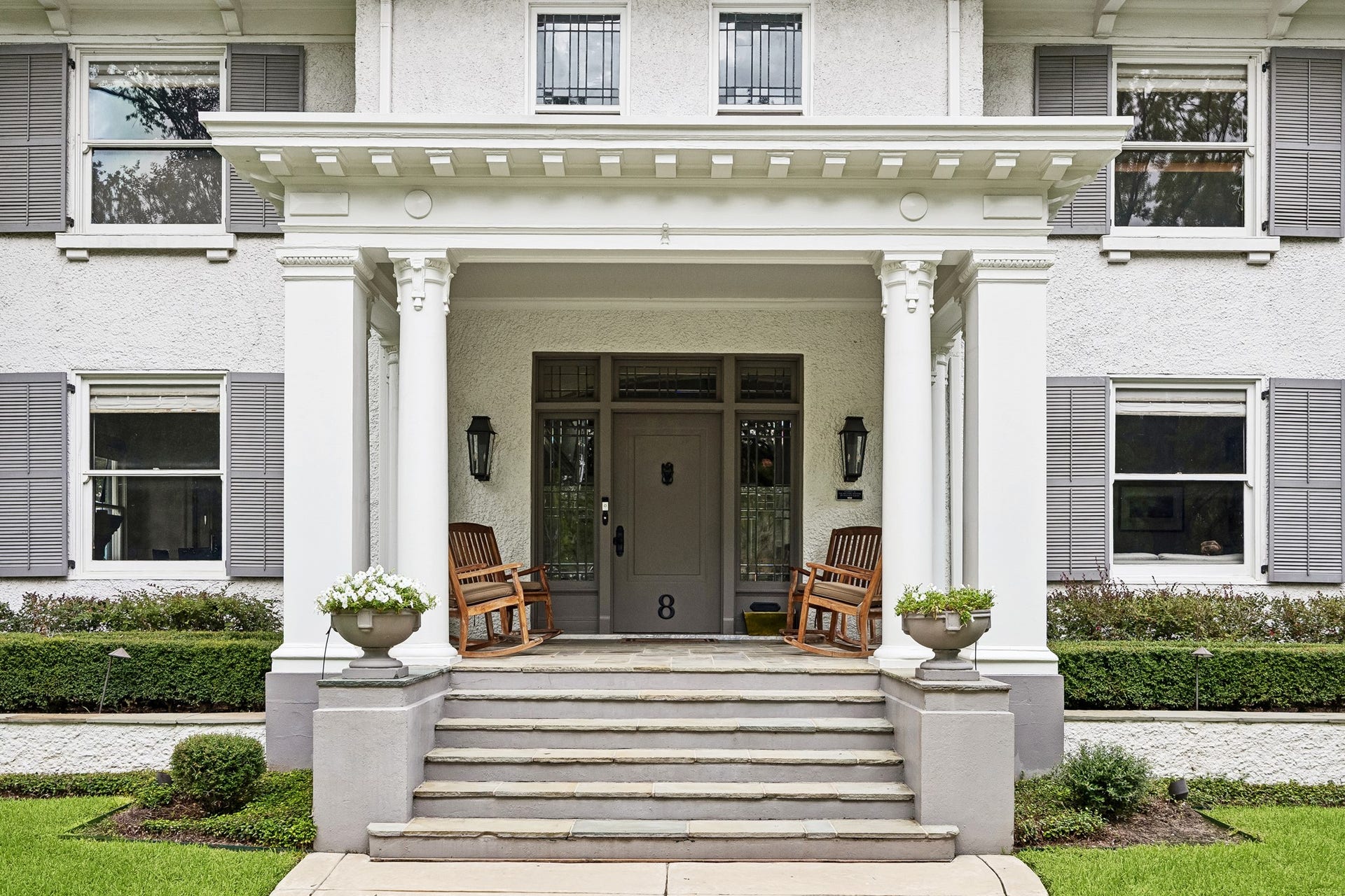 8 Courtlandt Place, Houston, TX 77006 A charming covered entry welcomes guests with stately columns, intricate architectural detailing and original divided-light windows.