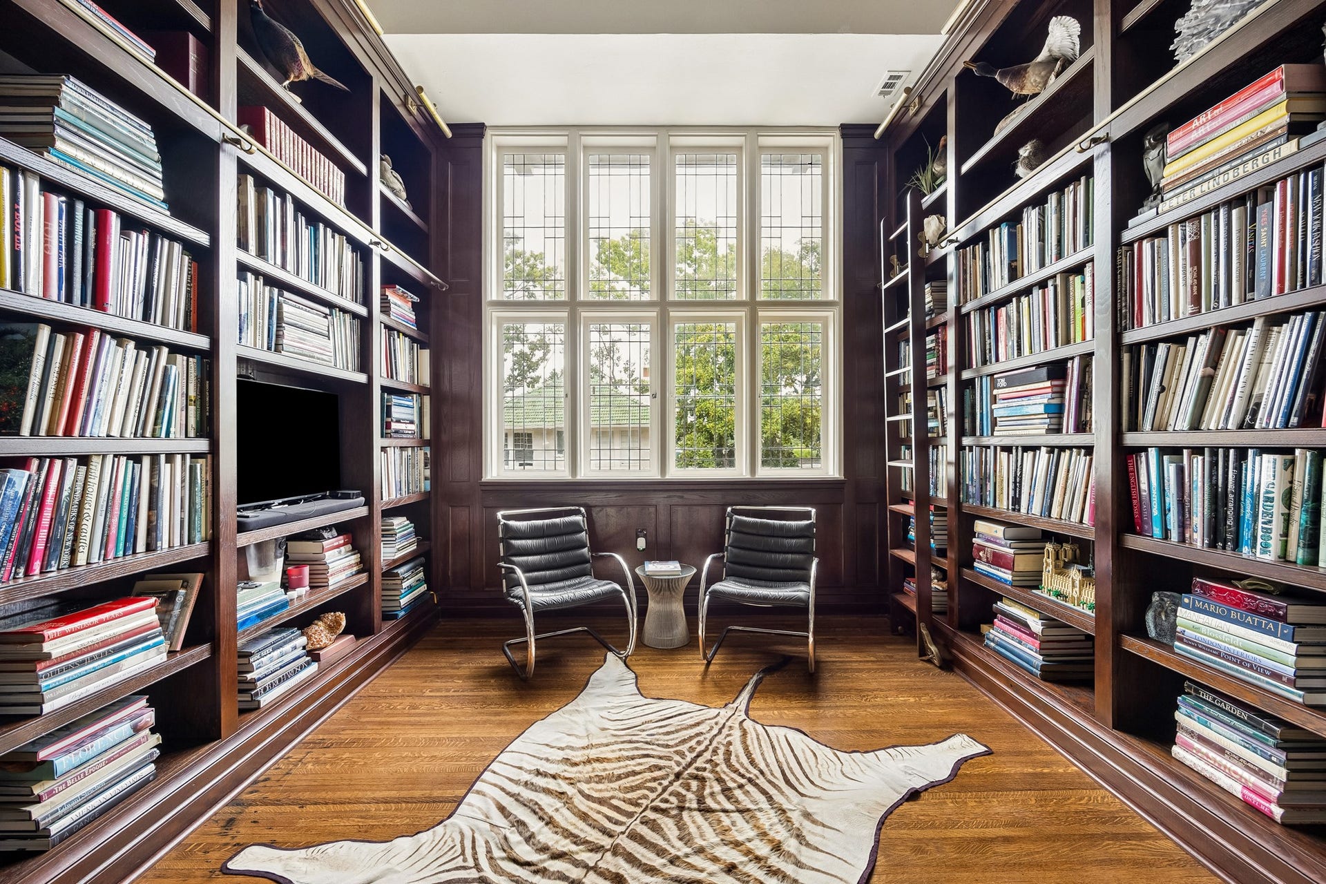 8 Courtlandt Place, Houston, TX 77006 A stunning transformation of the second-floor landing into an intimate library, featuring richly stained custom bookshelves, rolling ladders and an impressive wall of original leaded-glass windows.