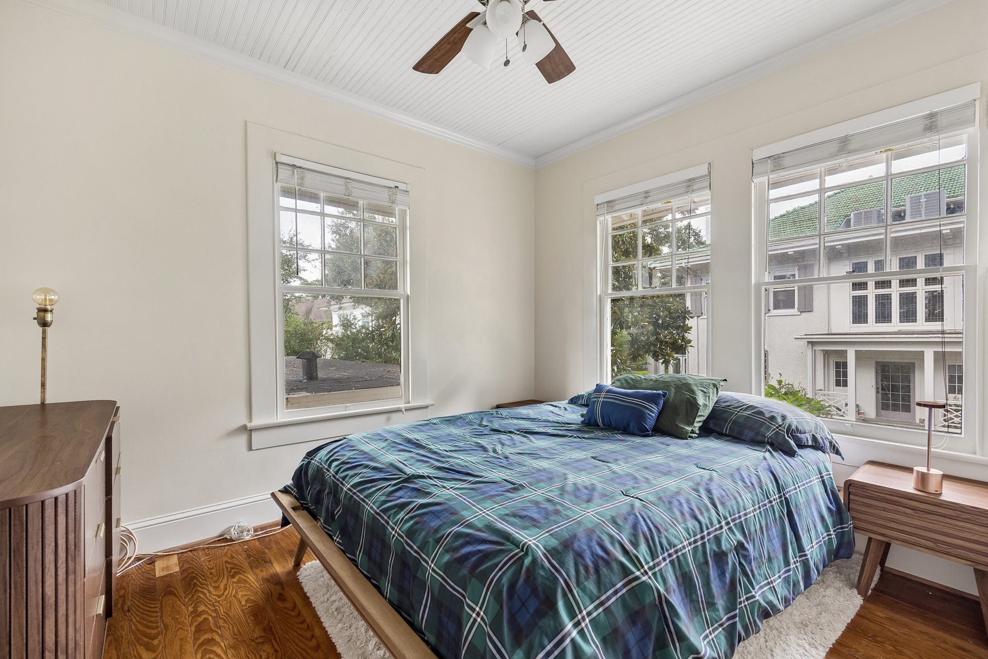 8 Courtlandt Place, Houston, TX 77006 The guest apartment's private bedroom features treetop views, traditional window trim and a charming beadboard ceiling.