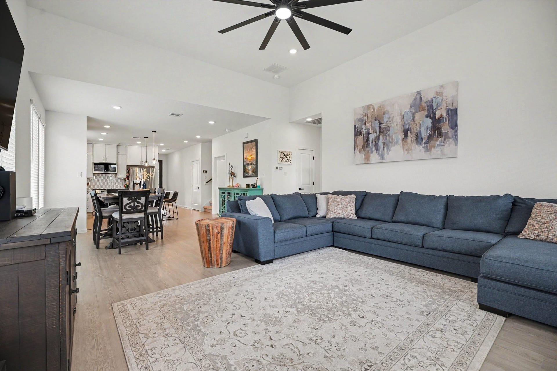 13716 Windward Mist Drive, La Marque, TX 77568 Spacious living room featuring soaring ceilings, expansive windows, and an open design that enhances the home's bright and airy feel.