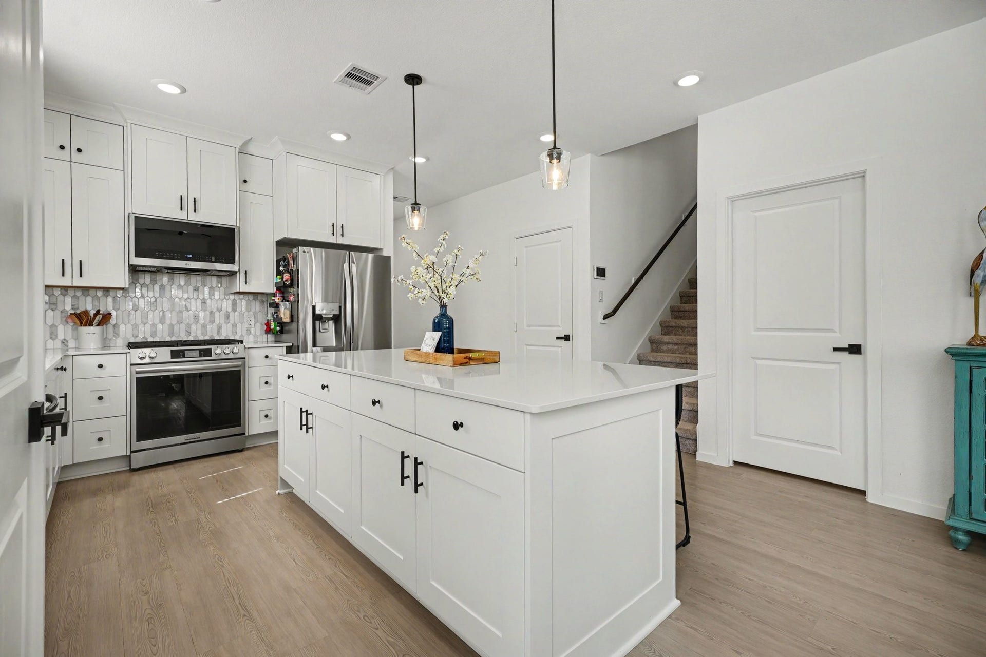 13716 Windward Mist Drive, La Marque, TX 77568 Bright and functional kitchen with extensive cabinet storage, generous workspace, and a seamless flow into the dining and living areas.