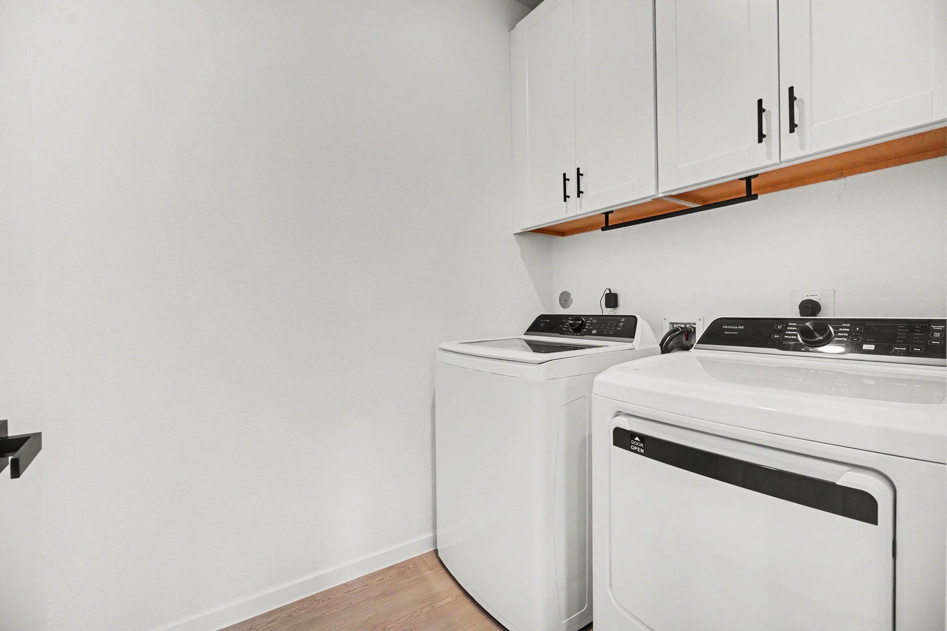 13716 Windward Mist Drive, La Marque, TX 77568 Laundry room with upper cabinetry providing additional storage for supplies and household essentials.