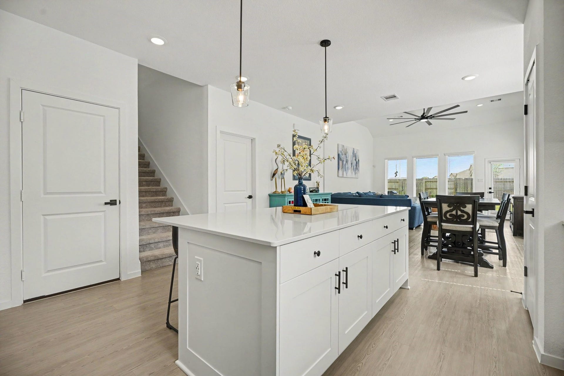13716 Windward Mist Drive, La Marque, TX 77568 Oversized island offers additional storage, workspace, and seating while maintaining an open connection to the dining and living areas.