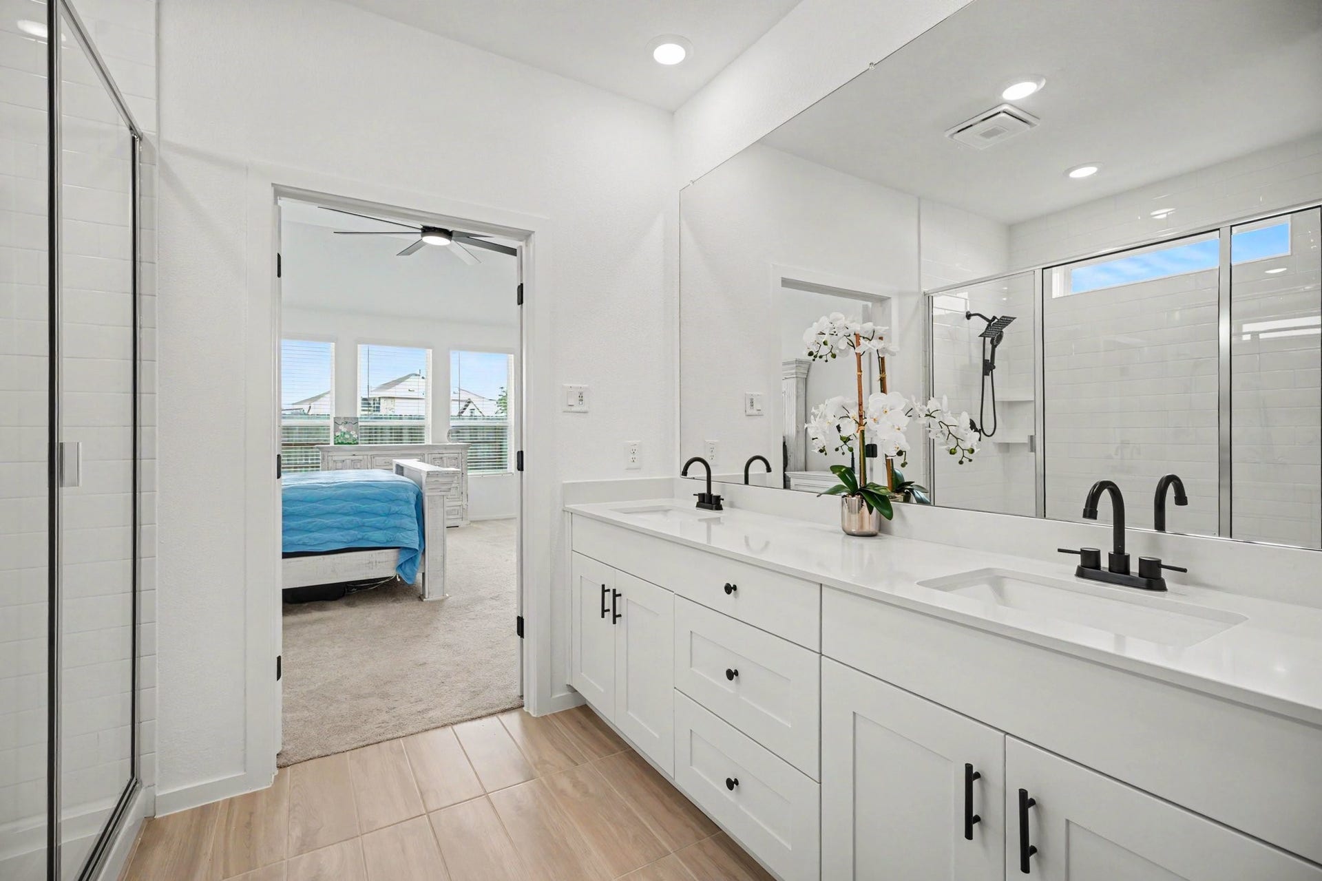 13716 Windward Mist Drive, La Marque, TX 77568 The spacious primary bath offers a functional layout with dual sinks, generous storage, and direct access to the primary suite.