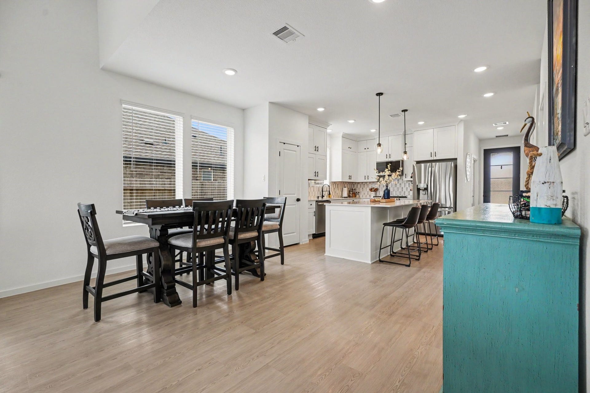 13716 Windward Mist Drive, La Marque, TX 77568 Open-concept dining area with abundant natural light and a seamless connection to the kitchen, creating an inviting and functional layout.