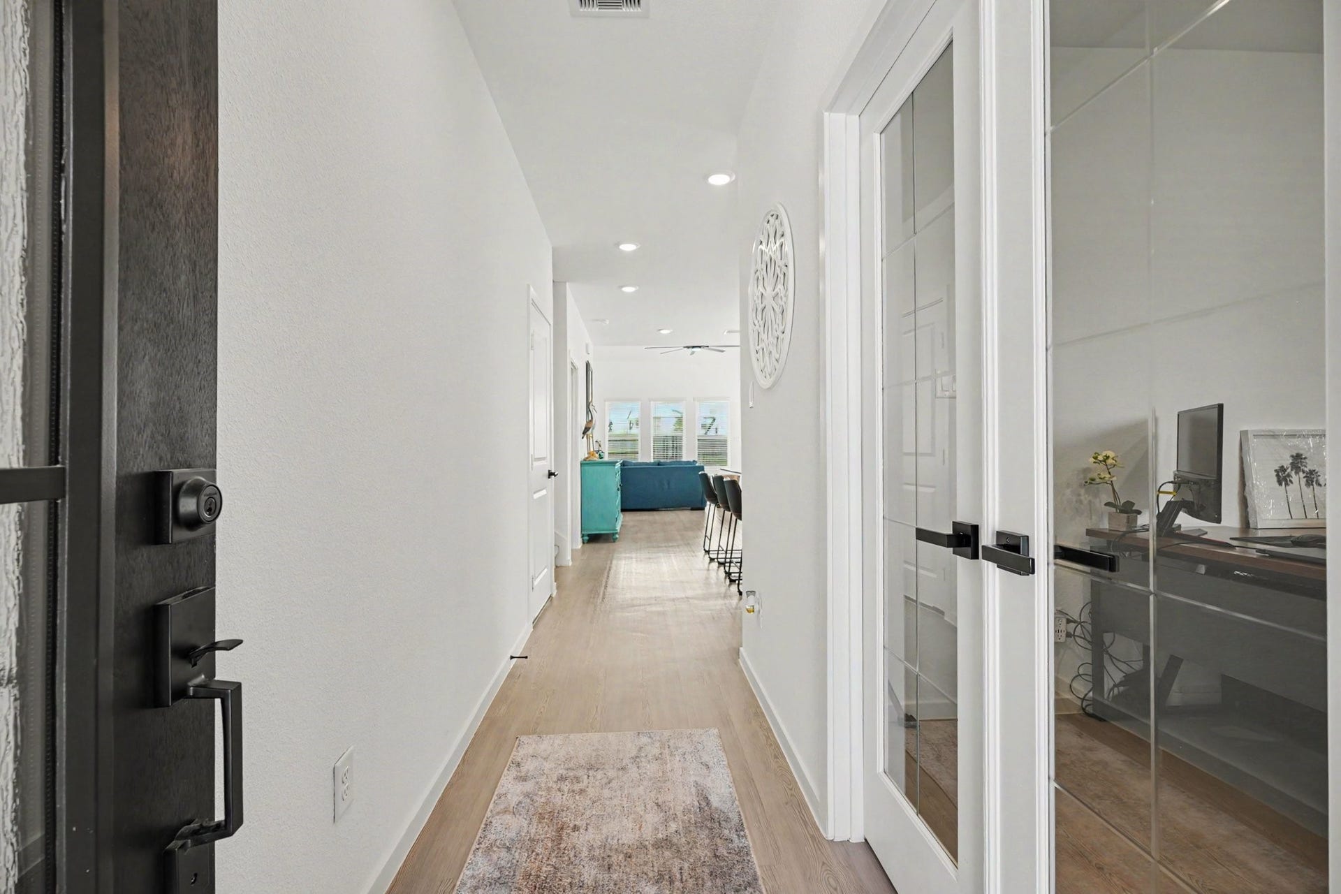 13716 Windward Mist Drive, La Marque, TX 77568 Welcoming entry foyer featuring luxury vinyl plank flooring, modern finishes, and a private study with glass French doors.