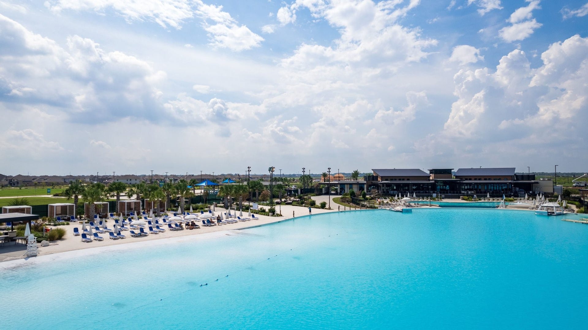 13716 Windward Mist Drive, La Marque, TX 77568 A crystal-clear lagoon creates a resort-inspired setting with sandy beaches, lounge areas, and waterfront recreation.