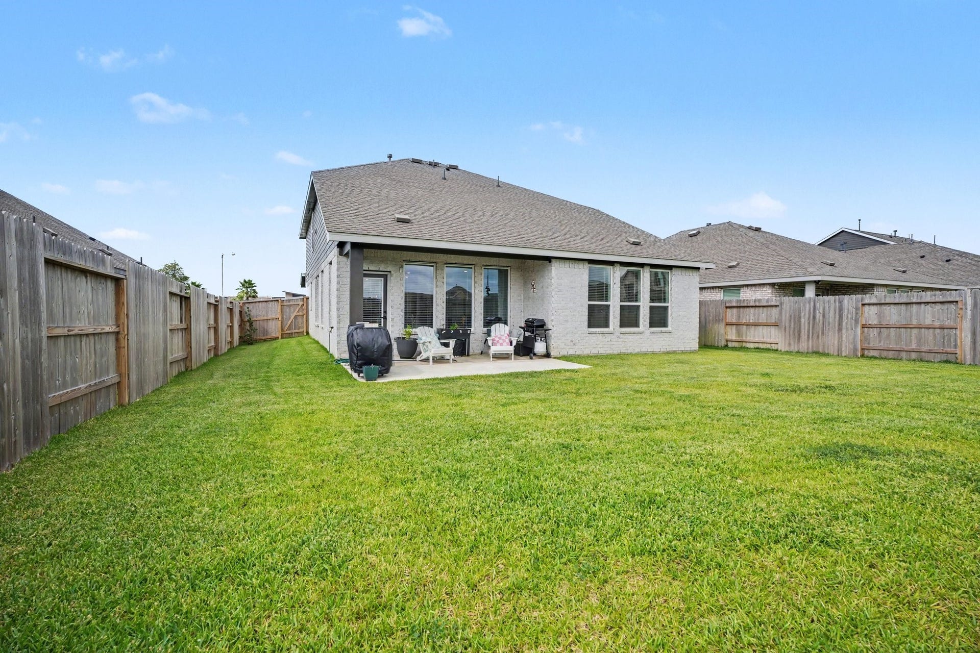13716 Windward Mist Drive, La Marque, TX 77568 Fully fenced backyard offering plenty of green space for outdoor activities, gardening, or pets.