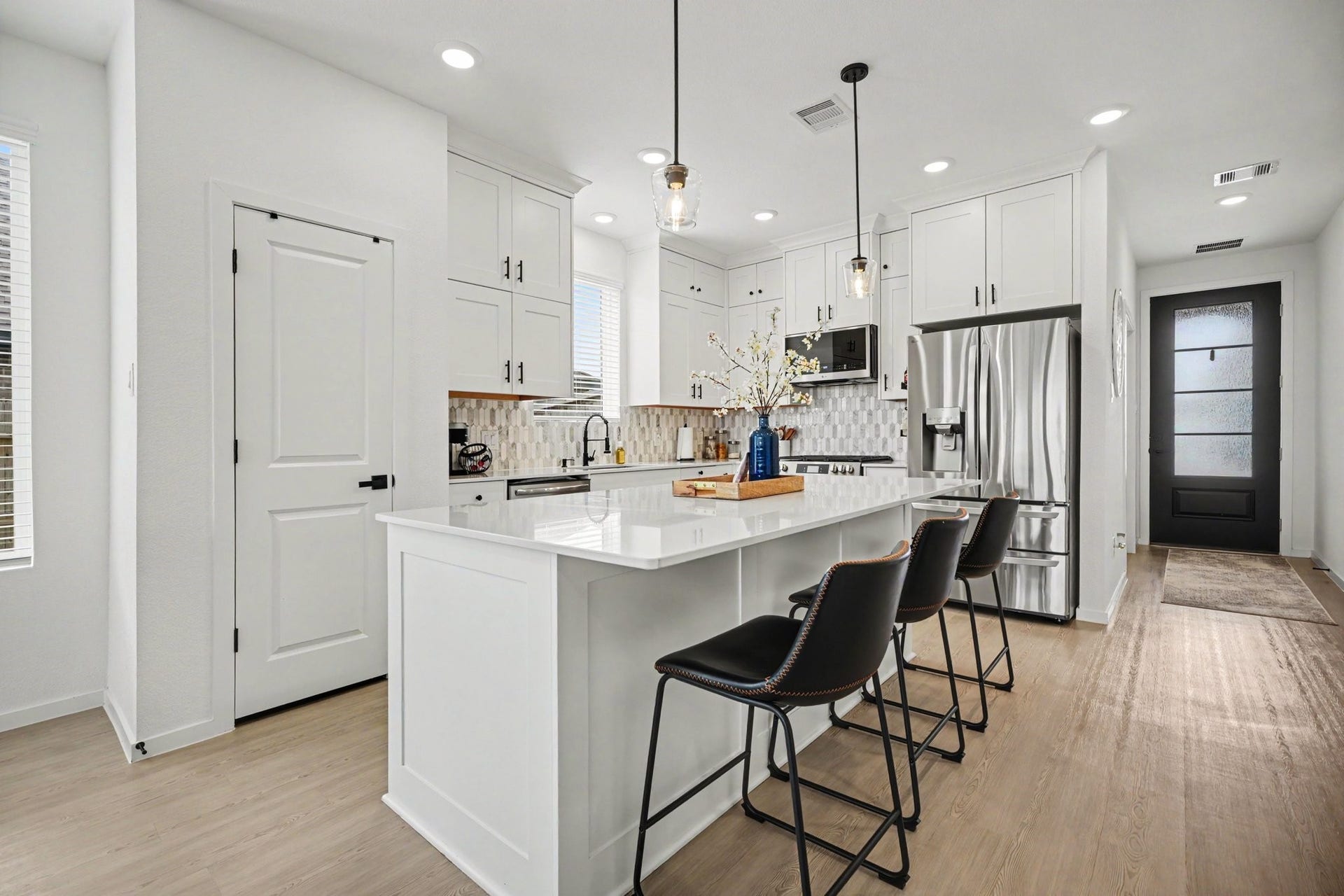 13716 Windward Mist Drive, La Marque, TX 77568 Spacious kitchen featuring stainless steel appliances, designer backsplash, and an oversized island perfect for gatherings.