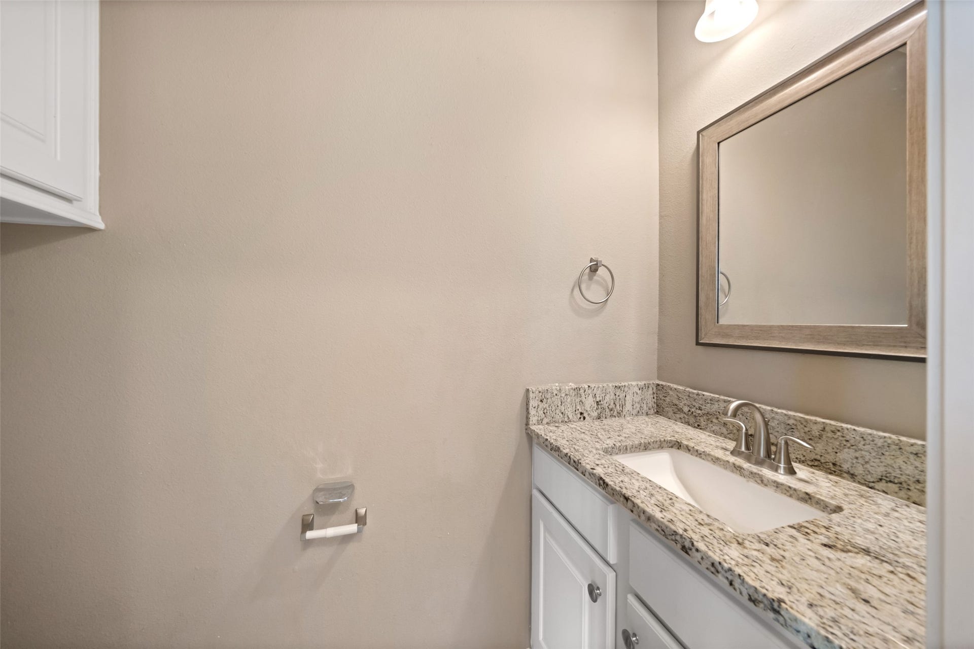 Half bath is downstairs, and also has granite counters, and plenty of cabinet space.
