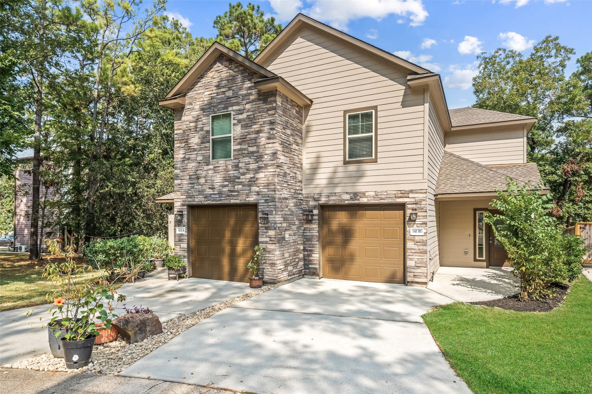 View of the right side of the dwelling. Each side has a private entryway, and both garages have automatic door openers.