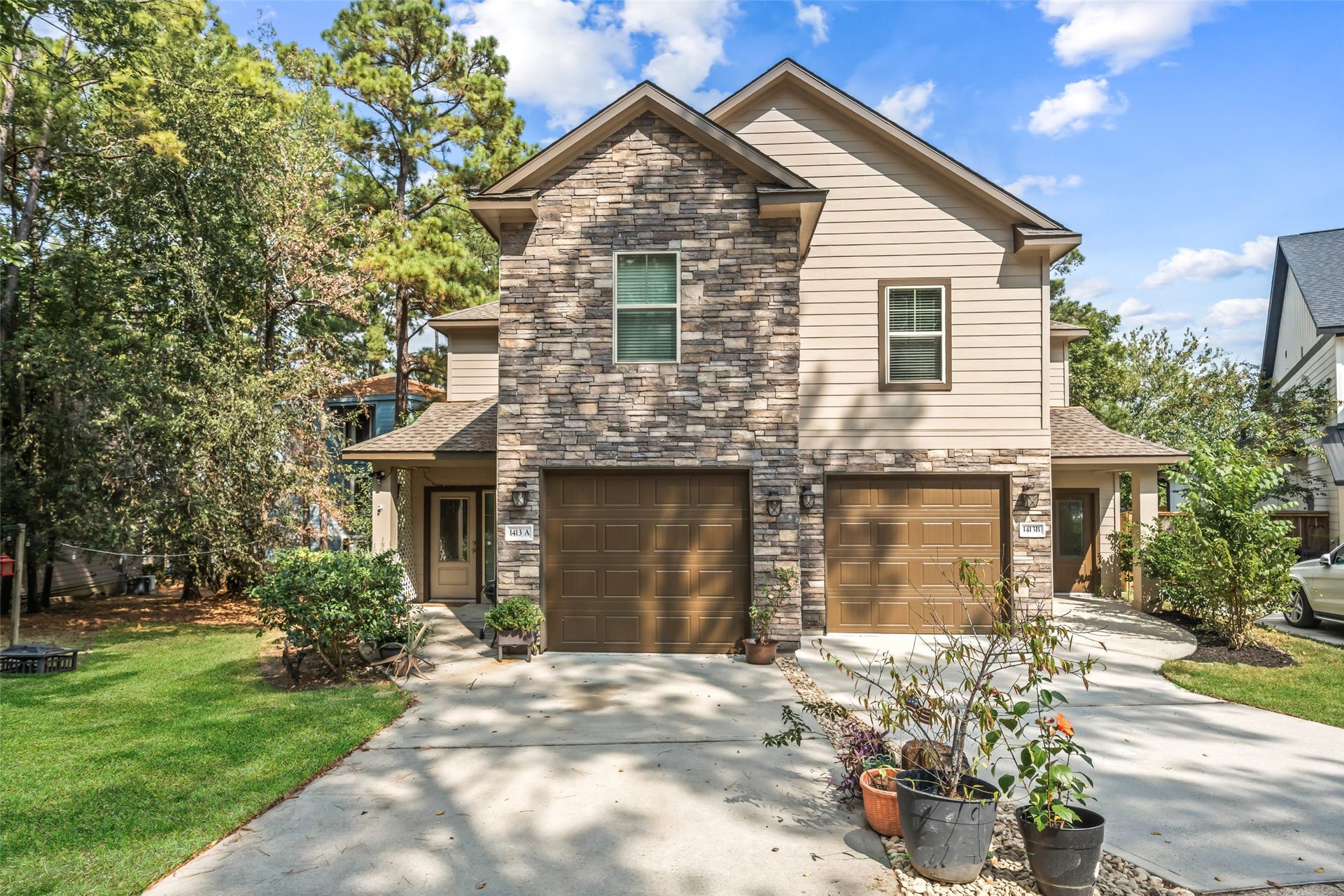 View of the front showing private one car garages for each side with additional parking on the driveway for each side.