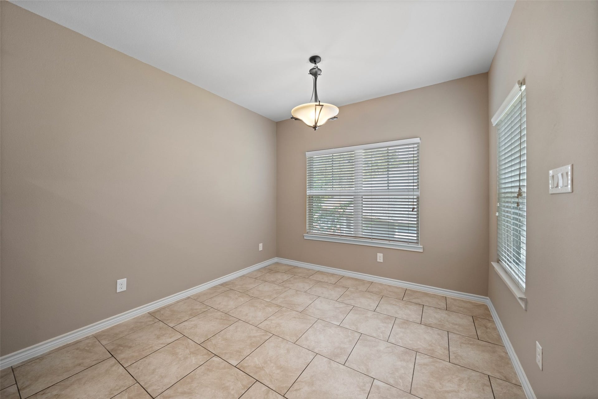 Nice open dining area with plenty of natural light coming in through the windows.