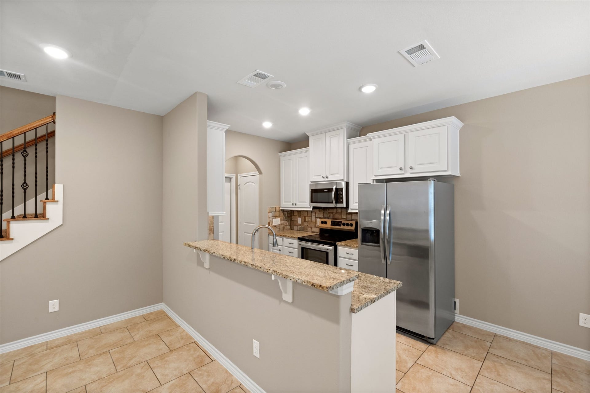Kitchens are open to the living area with breakfast bars.