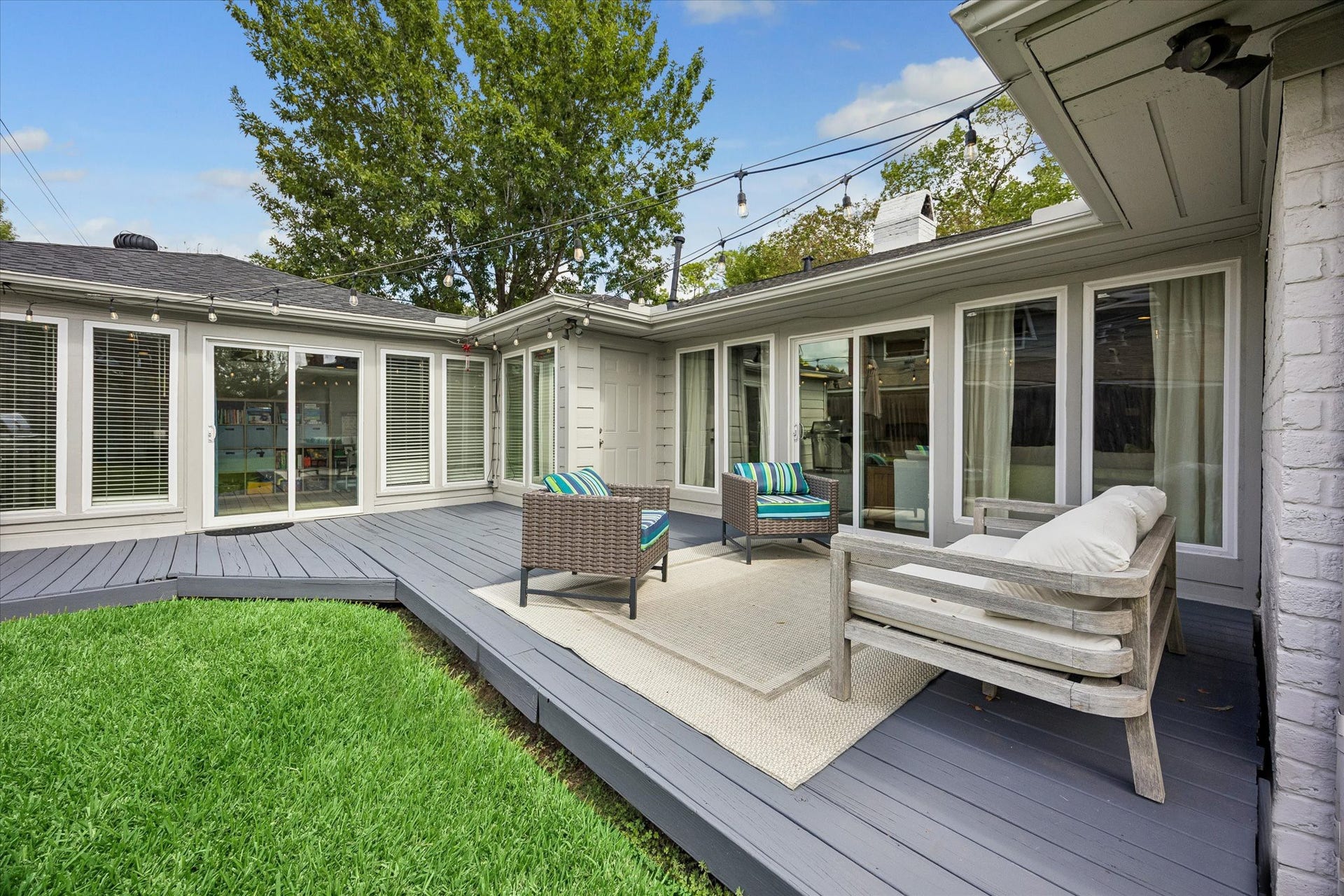 Seamlessly blending indoor and outdoor living, this expansive deck is accessible from multiple points throughout the home, creating a natural flow for any occasion.