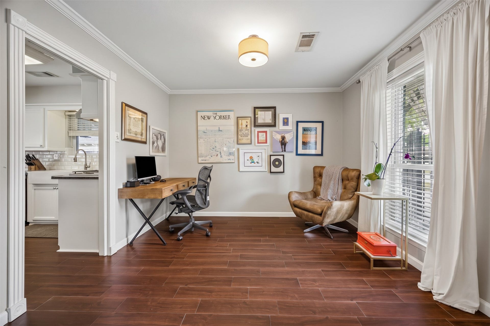 The office is nestled between the kitchen and formal dining room, offering a seamless flow for your workday. The wood-look tile floors continue throughout most of the home.