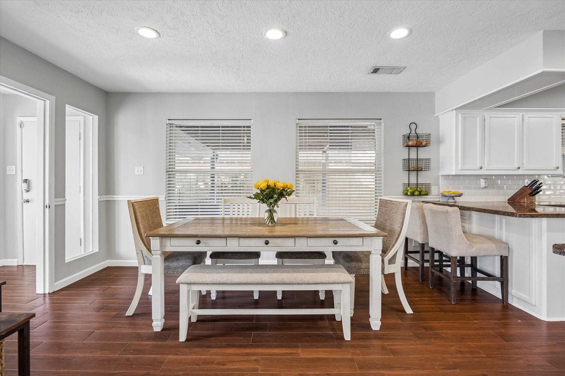 The expansive breakfast room is complemented by additional seating at the breakfast bar. From here, the layout flows seamlessly into a versatile indoor breezewaya perfect spot for a custom mudroom.