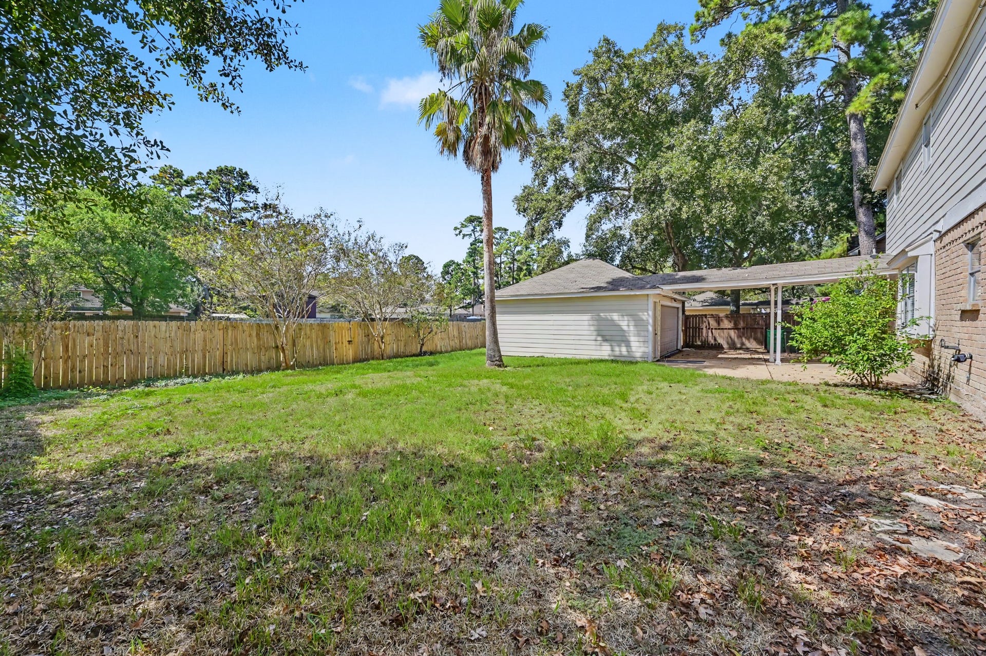 A spacious, fenced backyard with plenty of room to run, play, or simply soak up a little sunshine.