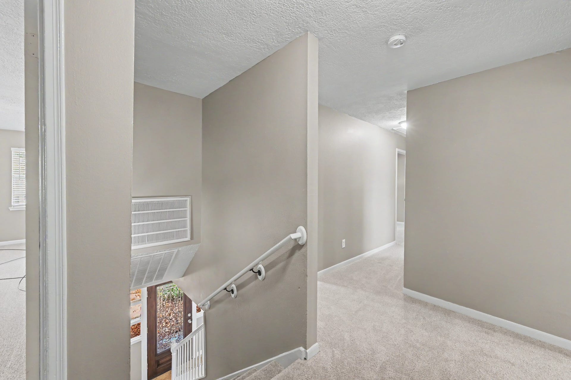 Fresh carpet and neutral colors make the upstairs feel bright, clean, and welcoming.