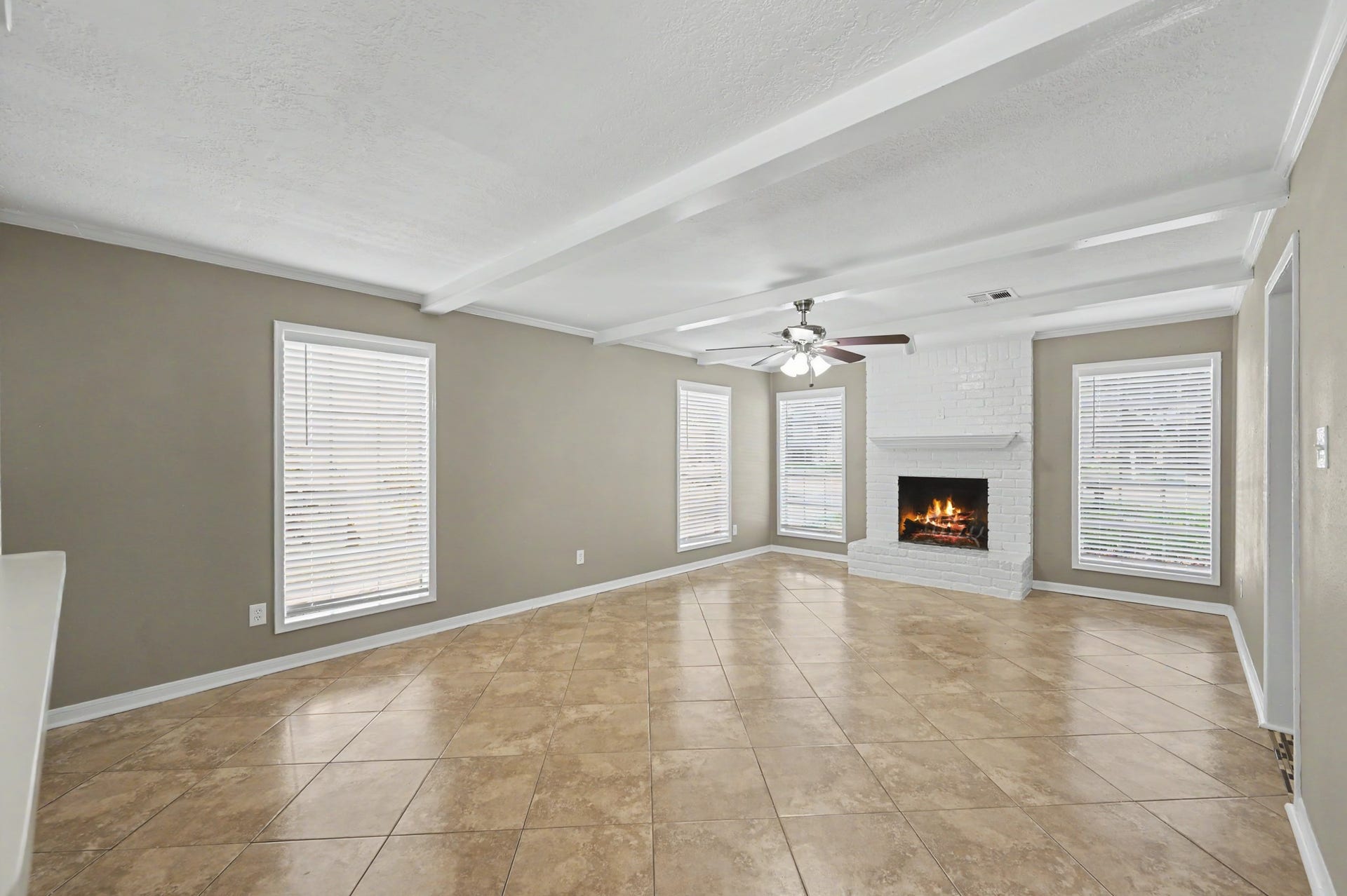 Plenty of room to kick back and relax, with a cozy brick fireplace and beautiful natural light.
