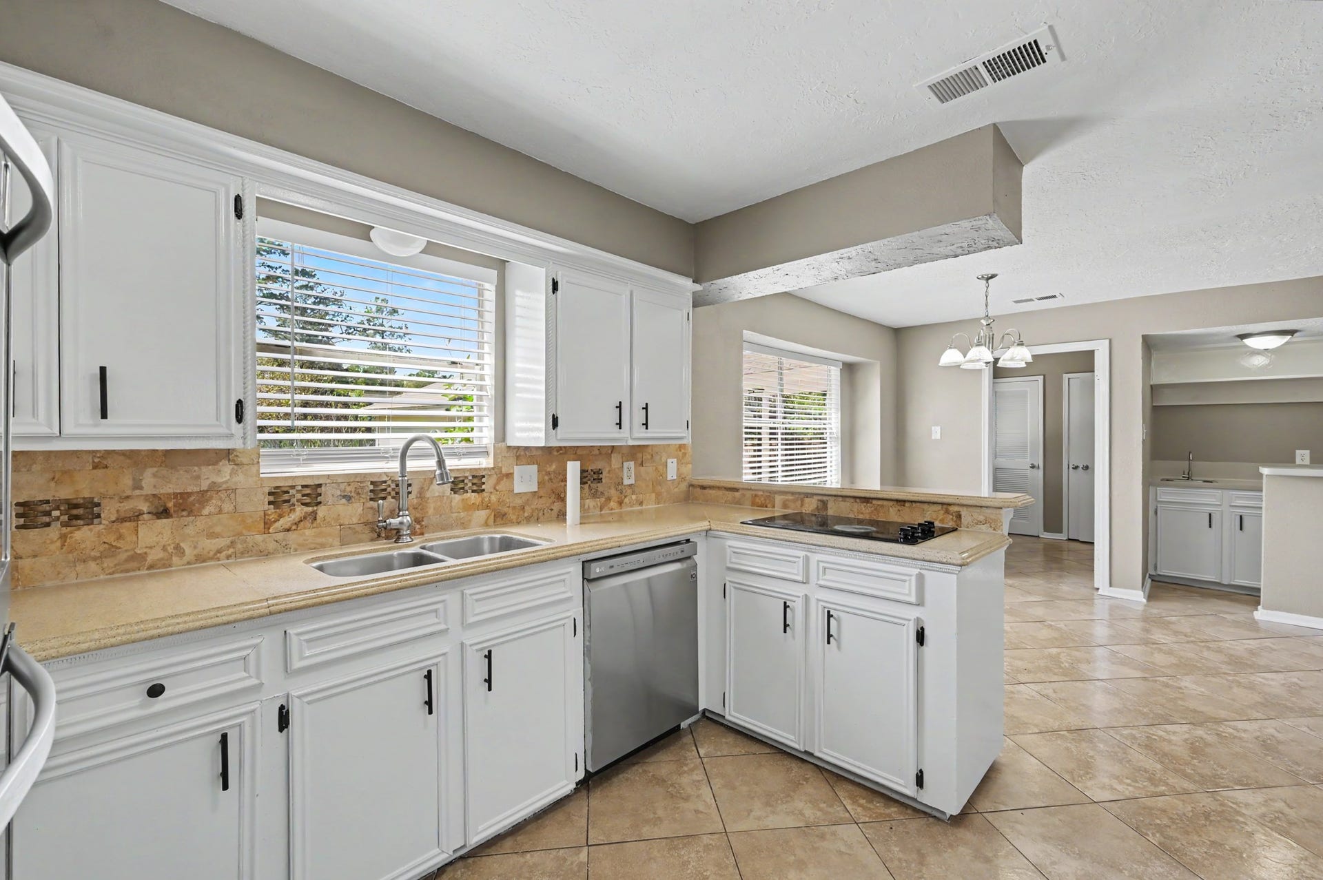 A functional kitchen layout with a breakfast bar that opens to the adjoining living spaces.