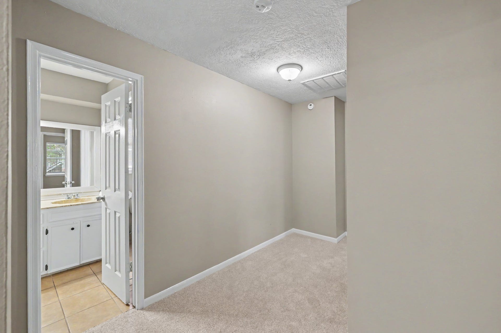 A comfortable bedroom with a ceiling fan and plenty of possibilities.