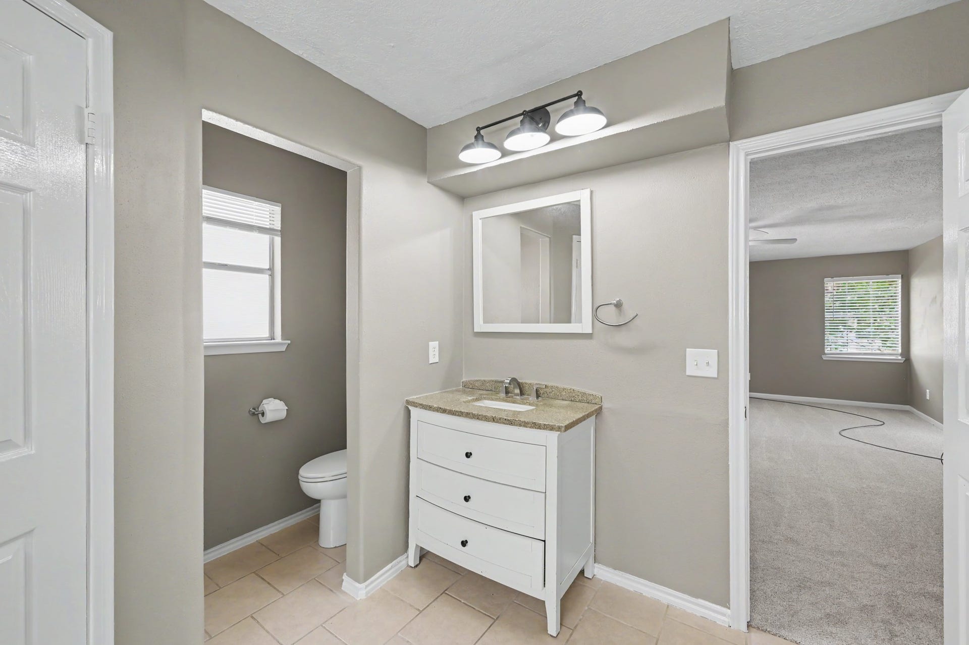 A separate vanity area and private toilet