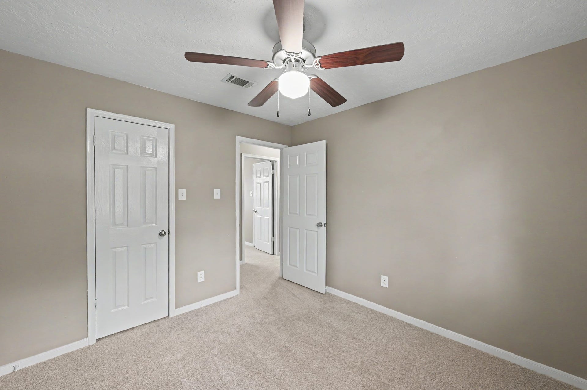 Another look at this bedroom's comfortable layout and closet space.