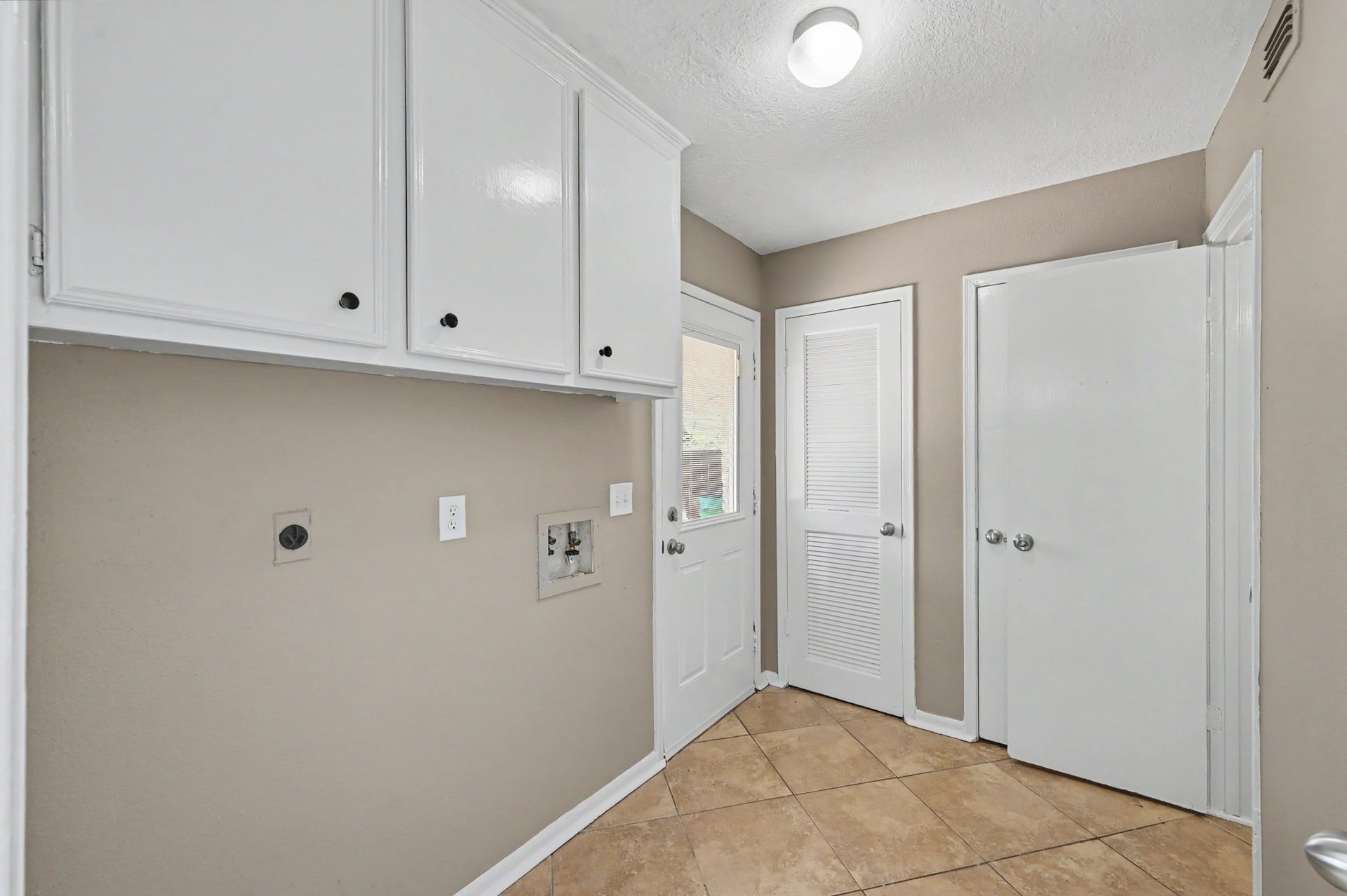 Laundry day made a little easier with overhead storage and a convenient location near the kitchen.