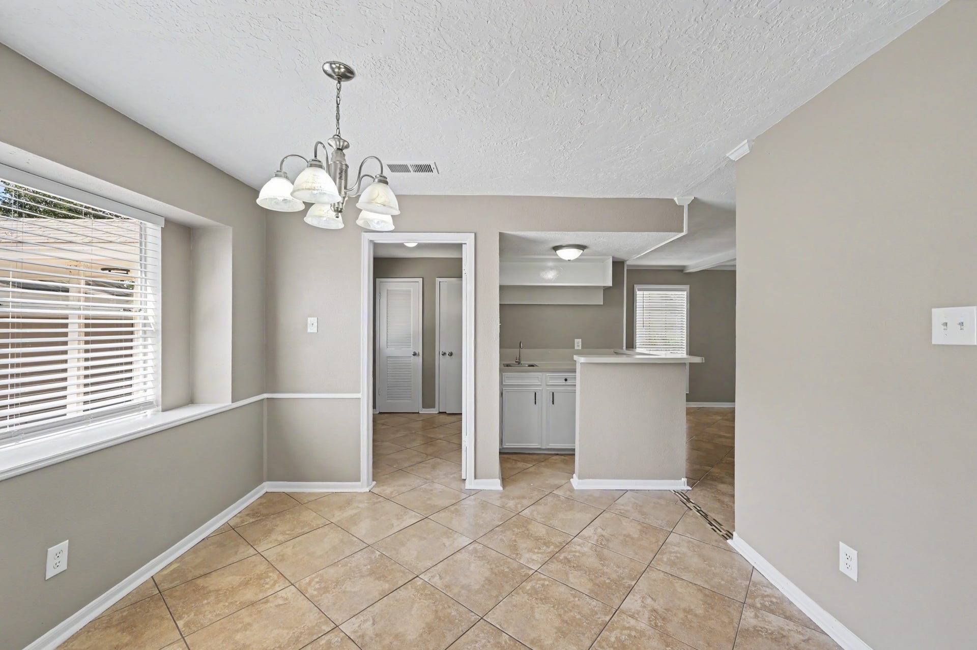 A cheerful breakfast room with natural light and easy access to the kitchen.