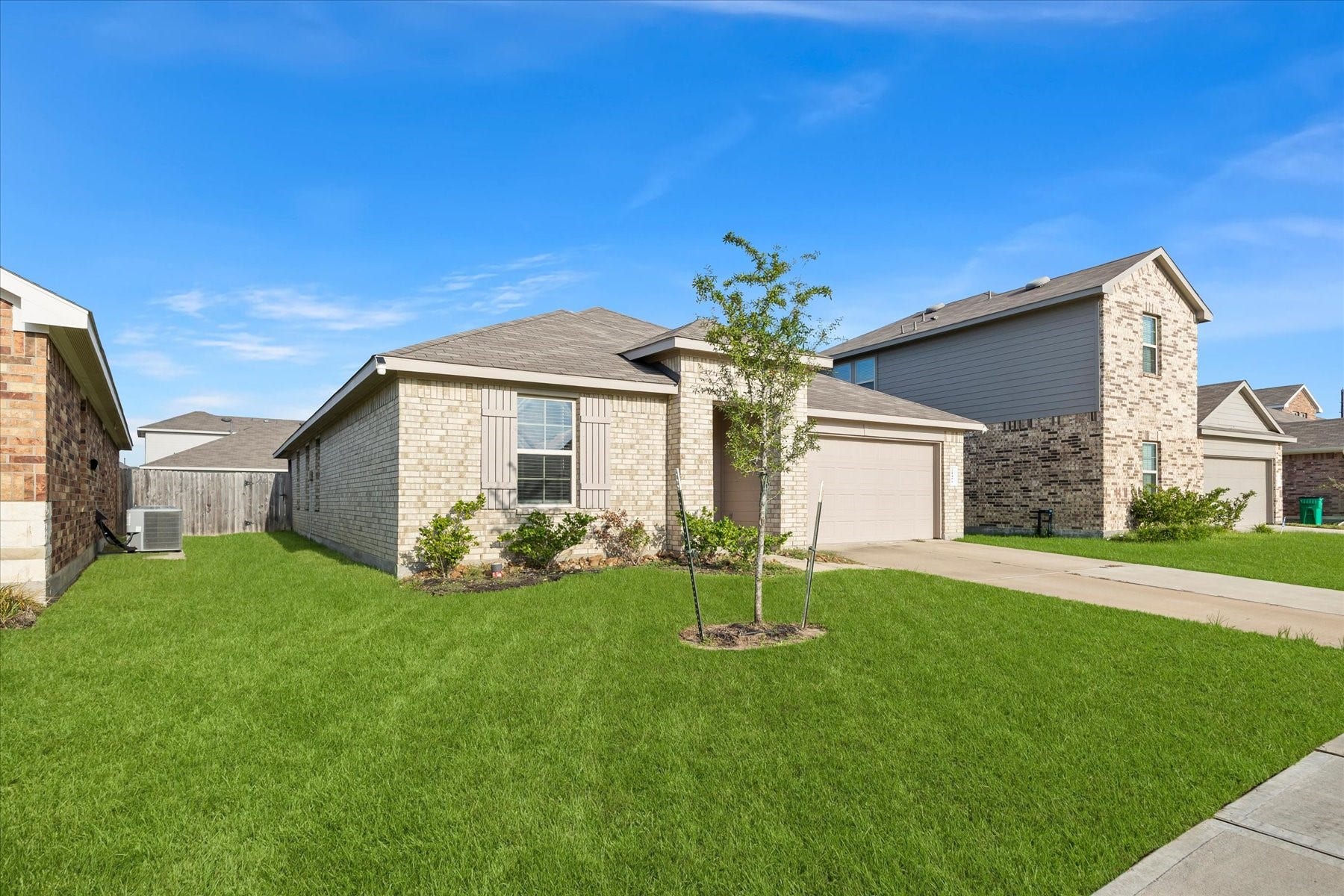 Charming front elevation with manicured lawn.