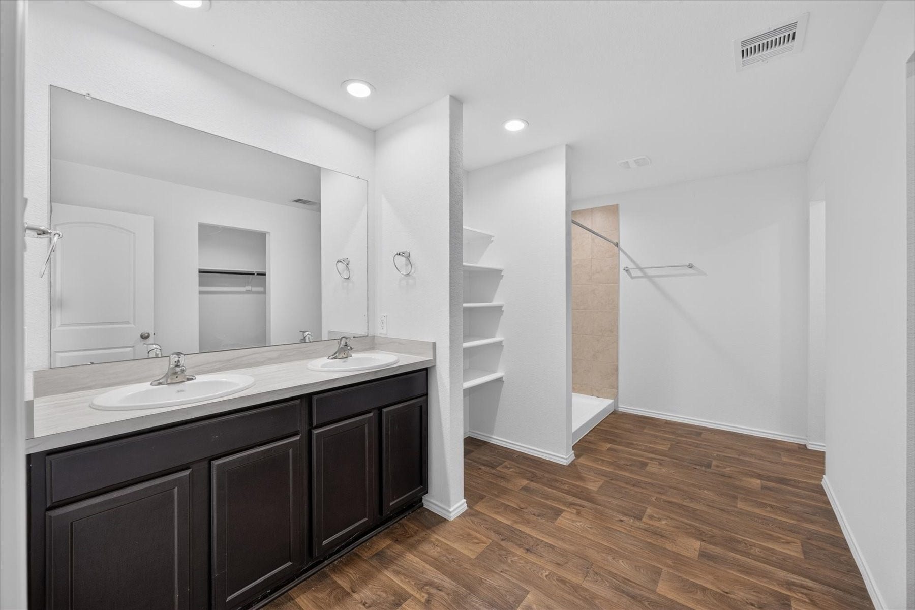Primary bath with dual sinks and ample storage.