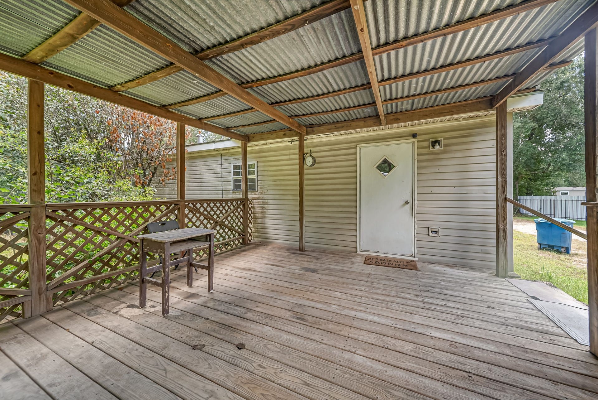 Designed for year-round enjoyment, the covered back porch offers a comfortable outdoor living space with plenty of room to relax and enjoy the country setting.