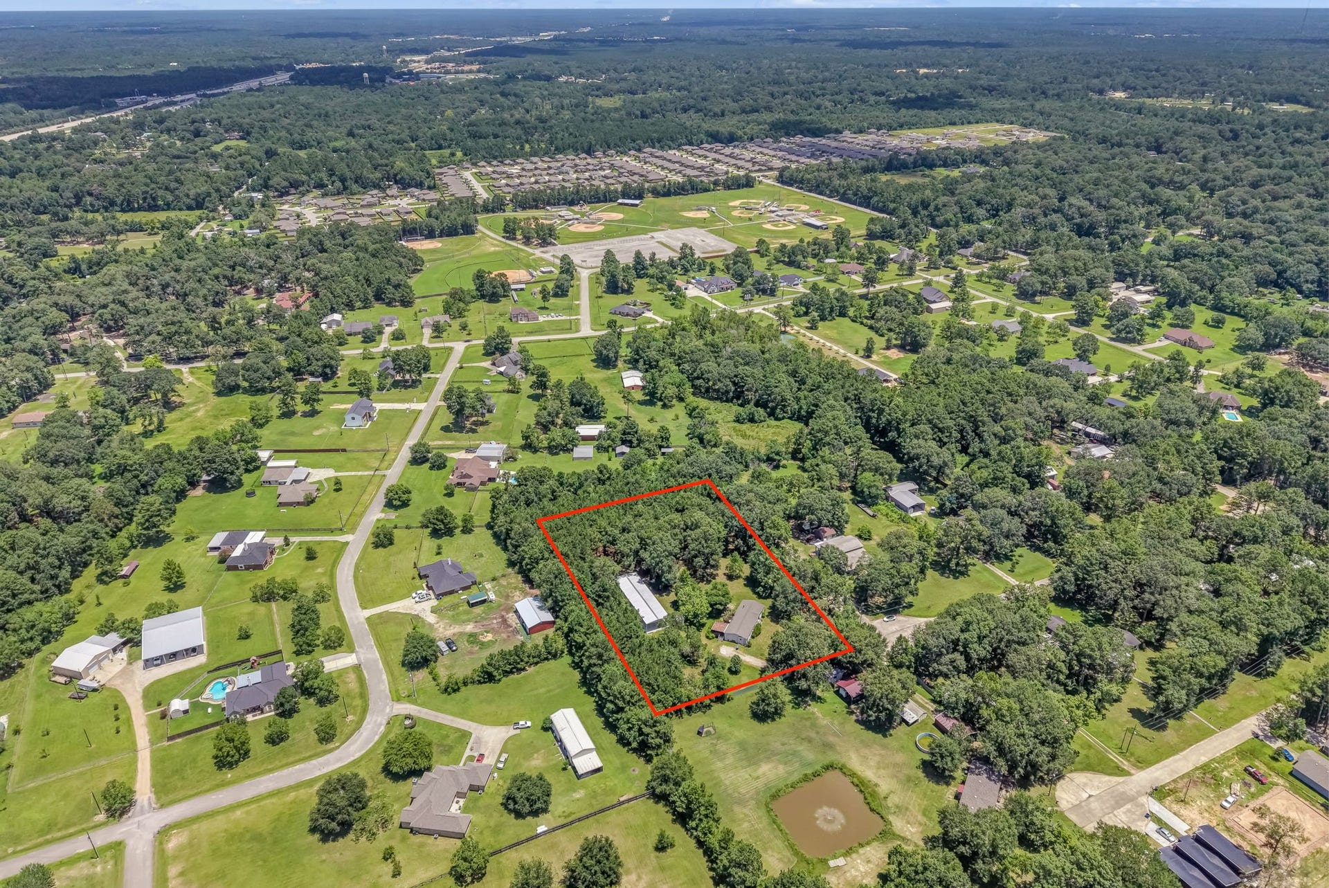 Experience the perfect balance of privacy and accessibility. Nestled in Deerbrook Village, this property offers nearly 3 acres of peaceful country living just minutes from everyday conveniences and major roadways.
