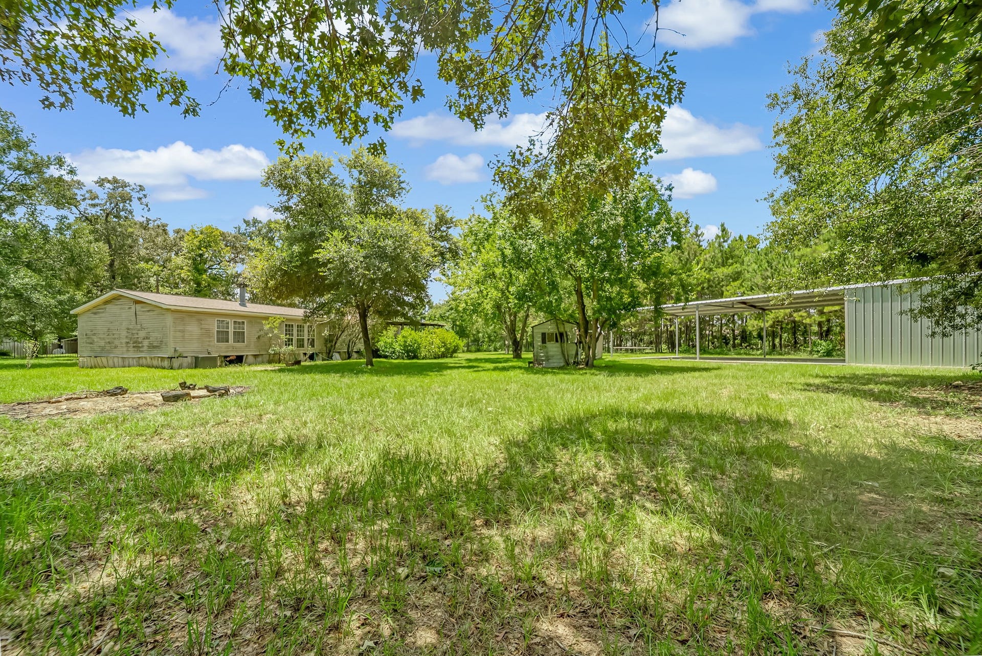 Enjoy a well-designed layout with the manufactured home, storage shed, and expansive metal building, each offering its own dedicated space while preserving the property's open feel and versatility.