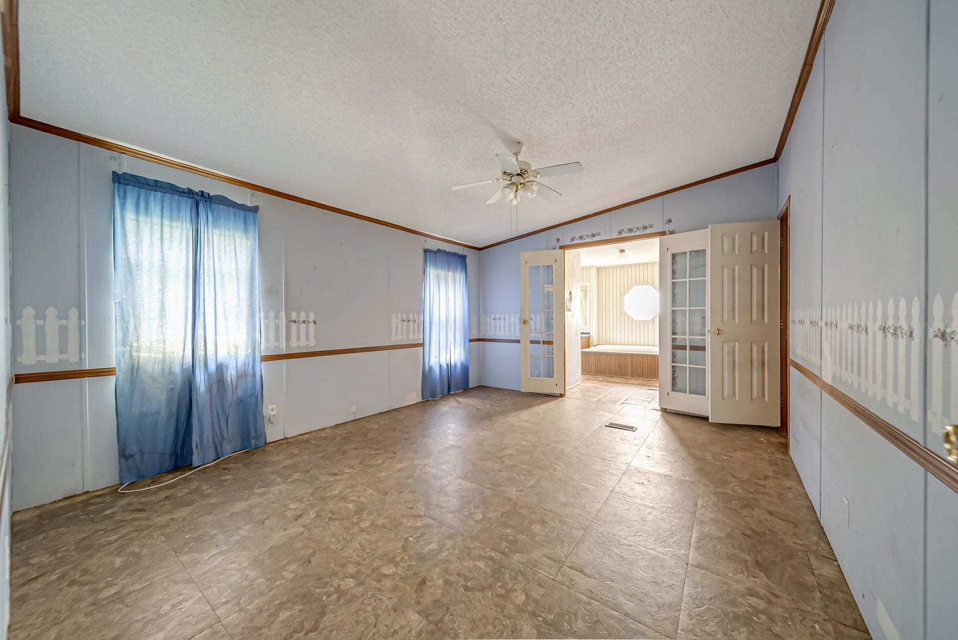 The expansive primary suite provides a comfortable retreat with ample space for a sitting area or additional furnishings, while the private en-suite bathroom adds everyday convenience.