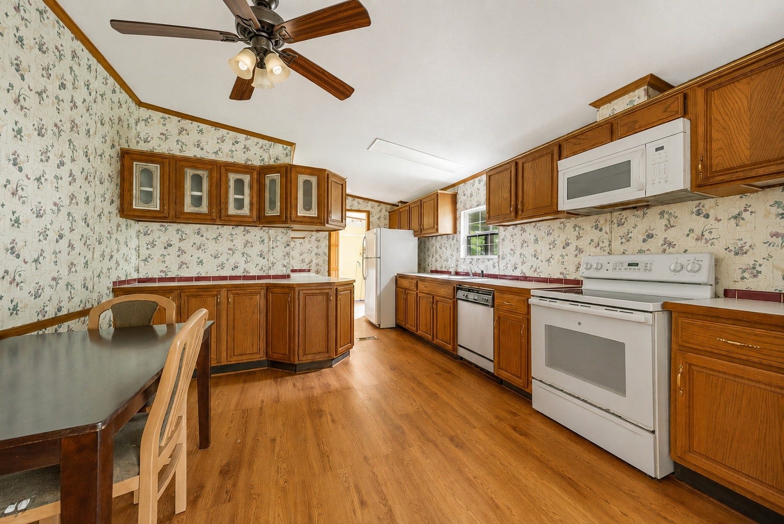 The heart of the home features a spacious kitchen with extensive cabinetry, generous counter space, and an adjoining dining area, offering endless potential to design a space that reflects your personal style.