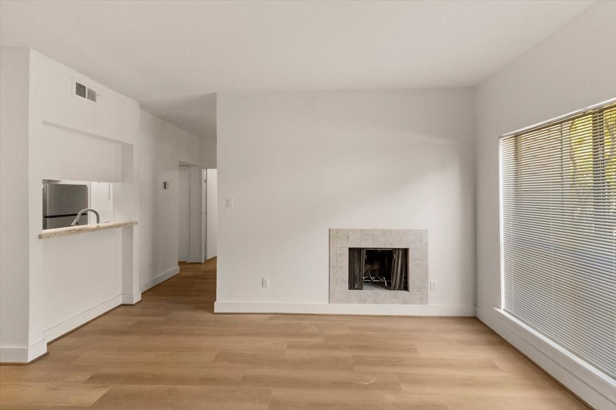 2025 Augusta Drive, #203, Houston, TX 77057 Living Area with Wood Burning Fire Place