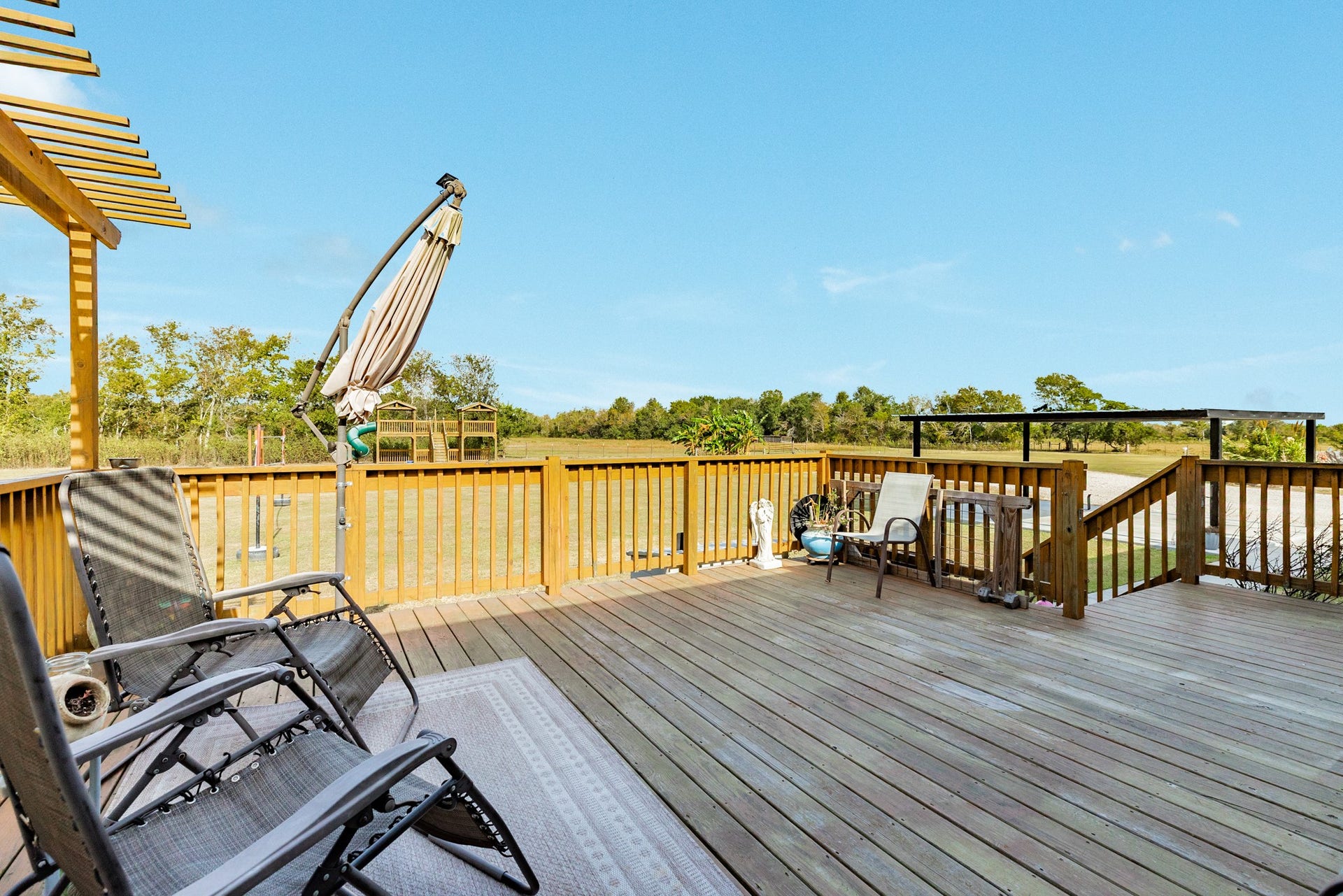 9120 County Road 196, Liverpool, TX 77577 Large wooden deck overlooking the acreage.