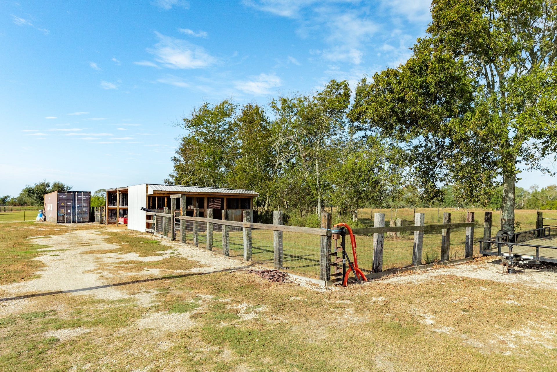 9120 County Road 196, Liverpool, TX 77577 Barn with covered storage and fenced areas.