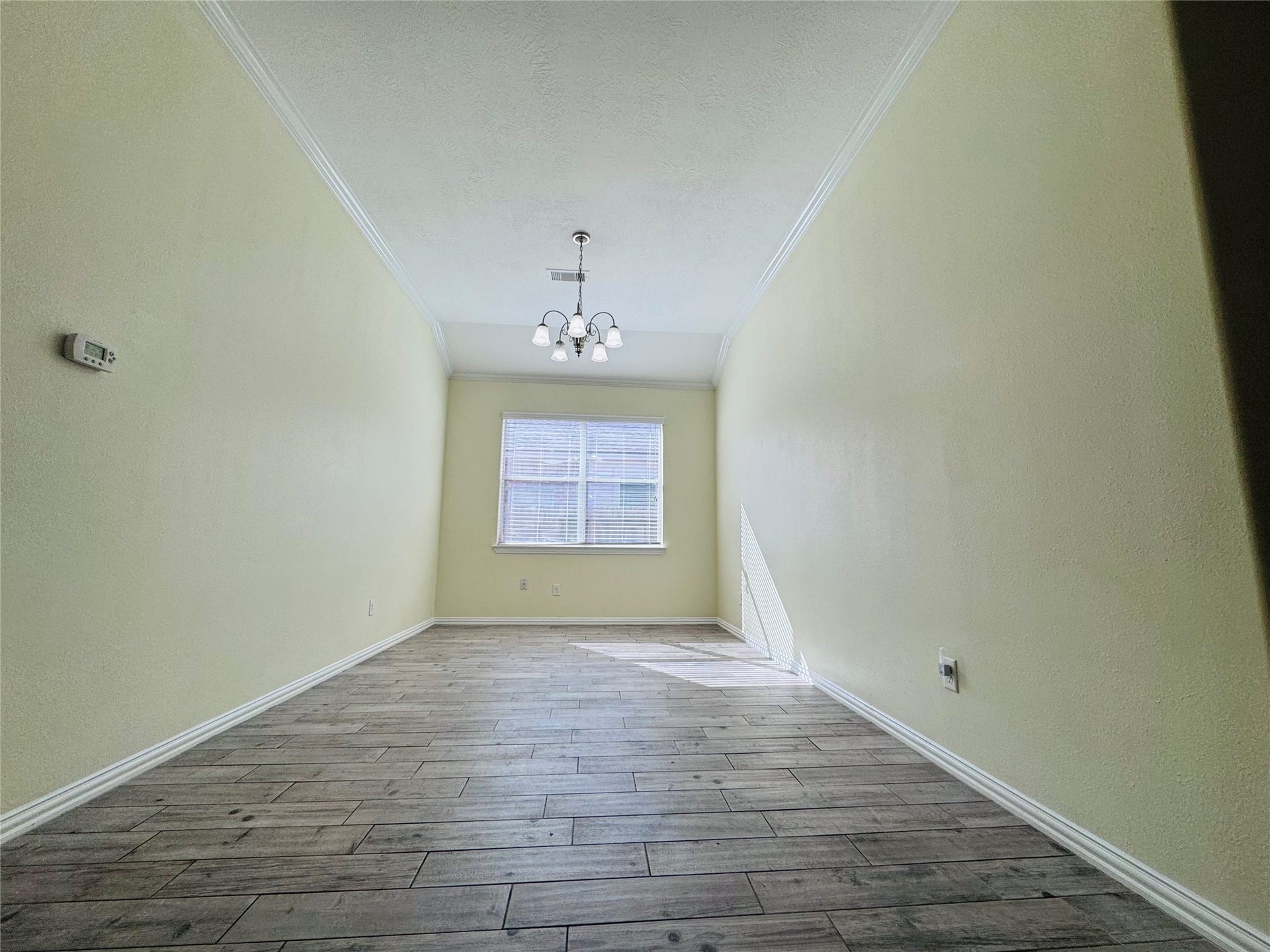Bright and inviting, this dining area boasts elegant flooring and ample natural light, perfect for intimate gatherings.