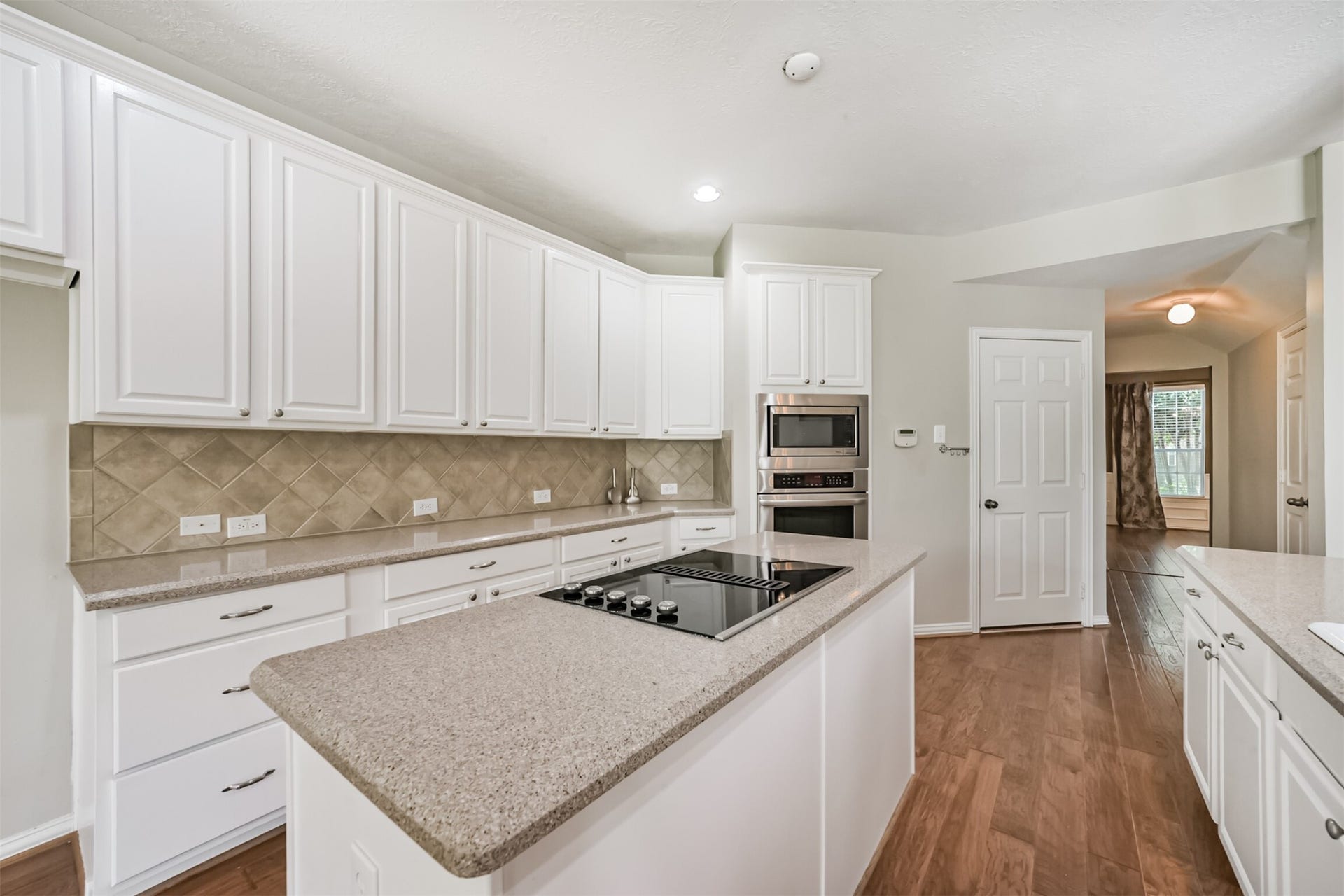 12614 Brazos Bend Trail, Humble, TX 77346 Electric cooktop with downdraft exterior vent. Plenty of storage in kitchen