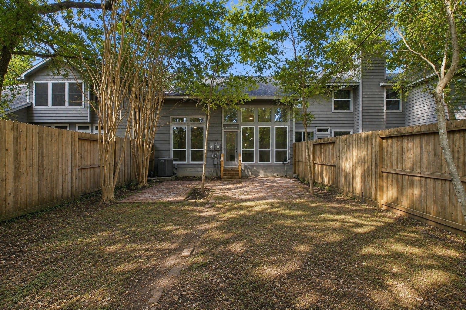 The fenced backyard offers mature shade trees and room to create an outdoor space that fits your needs.