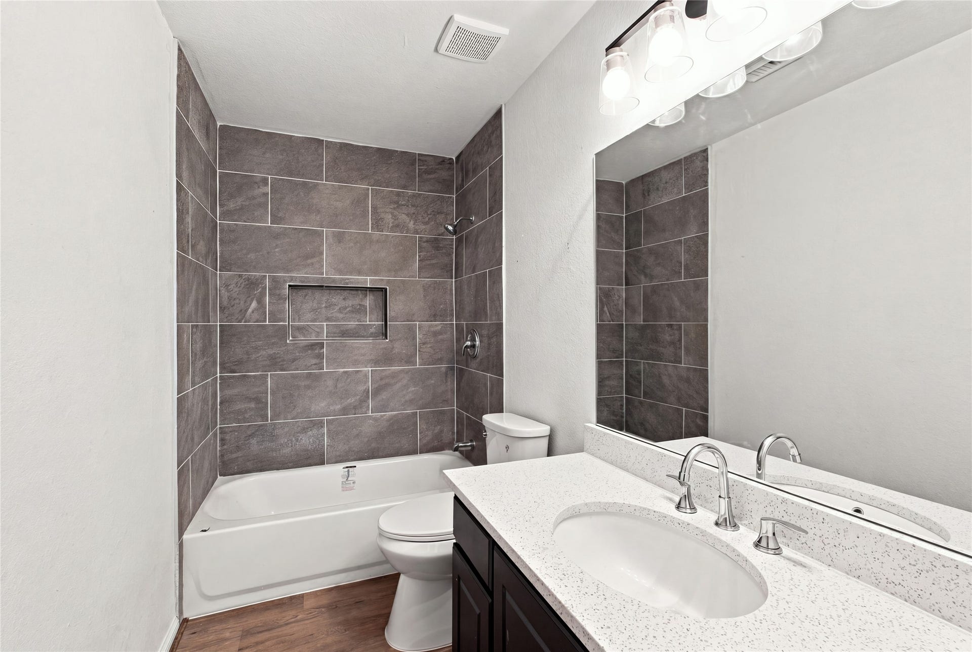 Updated second full bath with a tub and shower combination, tiled surround and generous vanity.