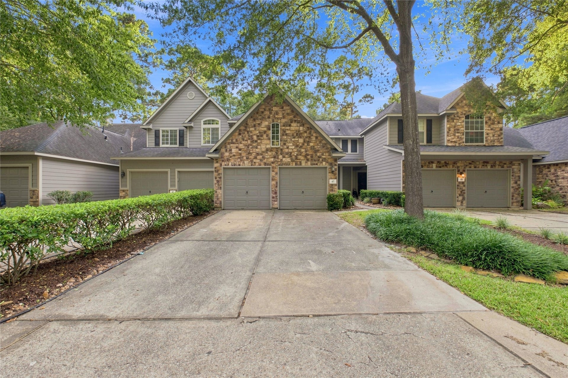 Welcome to 47 Alderon Woods Place, a two-story townhome in The Woodlands Village of Alden Bridge.